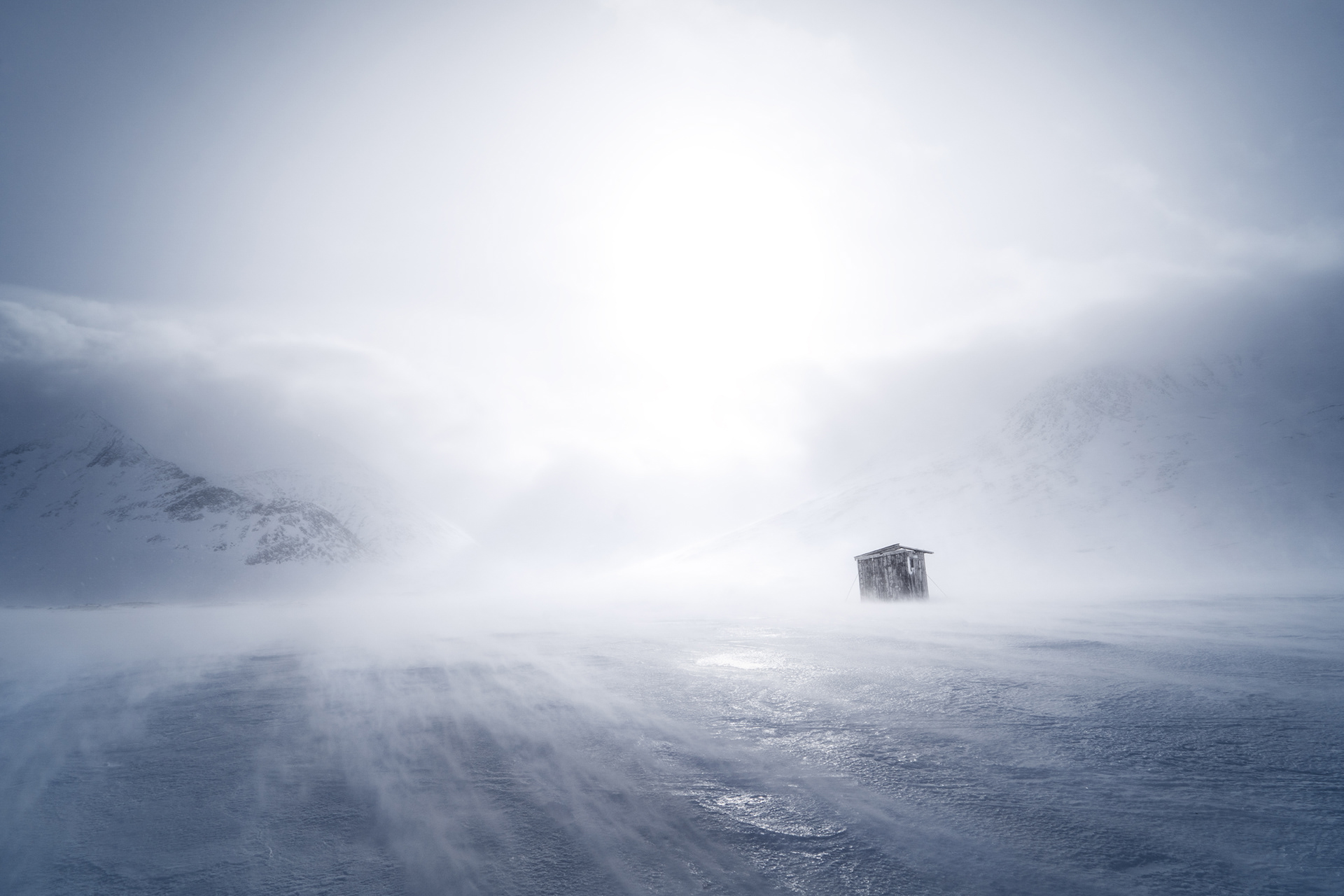 A sami reindeer herder's toilet hut braces the strong winds in a winter storm in the middle of Sarek National Park, Swedish Arctic. Winter