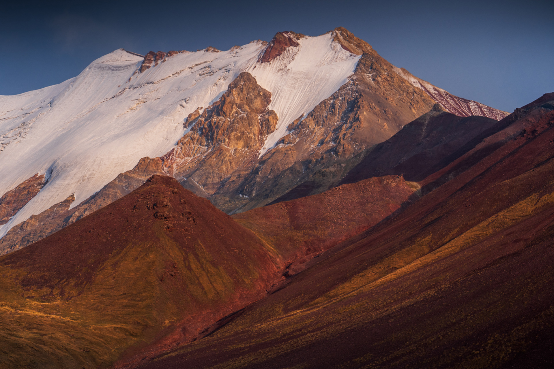 Sunset adorning the colourful and glaciated peaks of the Alay Range of the Pamir Mountains, Kyrgyzstan
