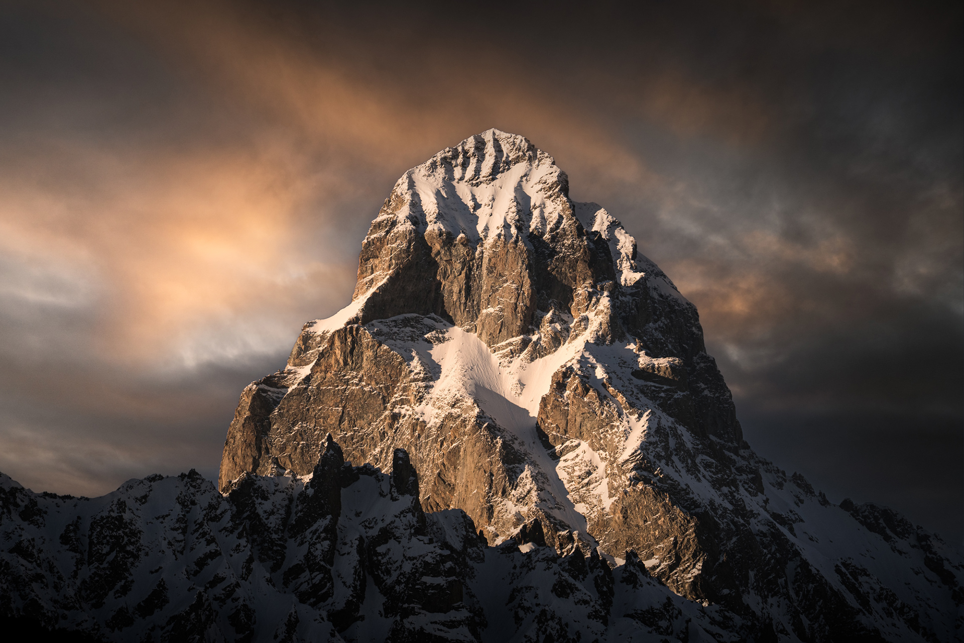 A dramatic photo of a sharp, snowy mountain called Mt Ushbha, in Georgia's Svaneti region.