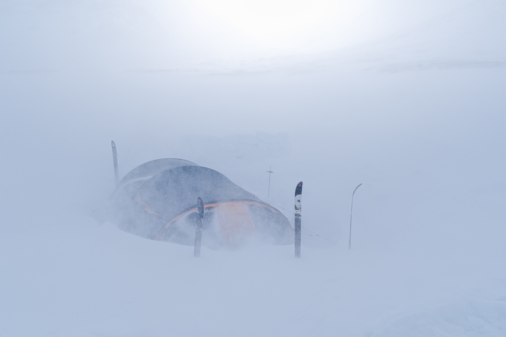 A Barents tent is half-submerged under the snow during an arctic winter snow storm in Sarek National Park, Sweden.
