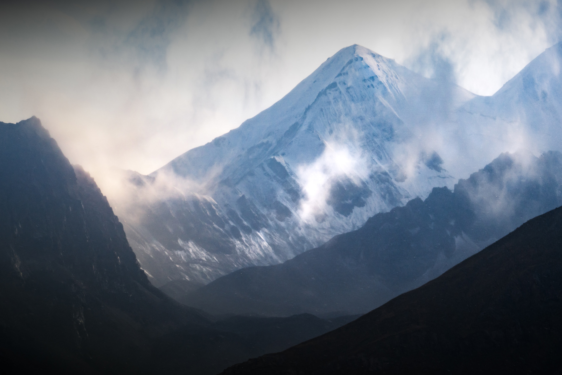 Misty peaks emerging from a storm in the Alay Range of the Pamir Mountains in Kyrgyzstan