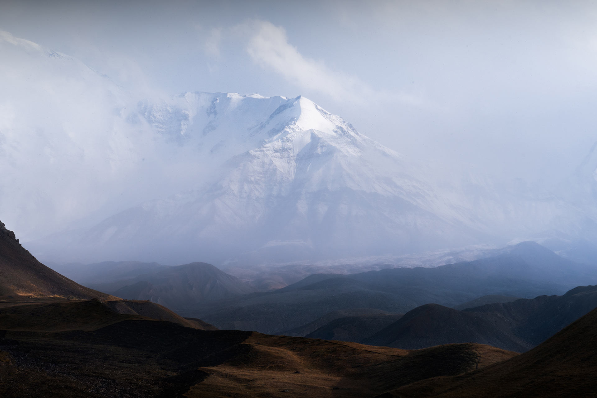 Misty Lenin Peak / Ibn Sina emerges, Alay Valley, Pamir Mountains, Kyrgyzstan