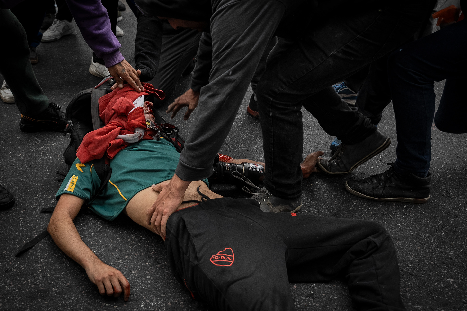 Photojournalist Pablo Grillo lies unconscious on the sidewalk after being hit by a tear gas grenade fired by police officer Héctor Guerrero in Buenos Aires, Argentina, on March 12, 2025. PHOTO/Santi Oroz.
