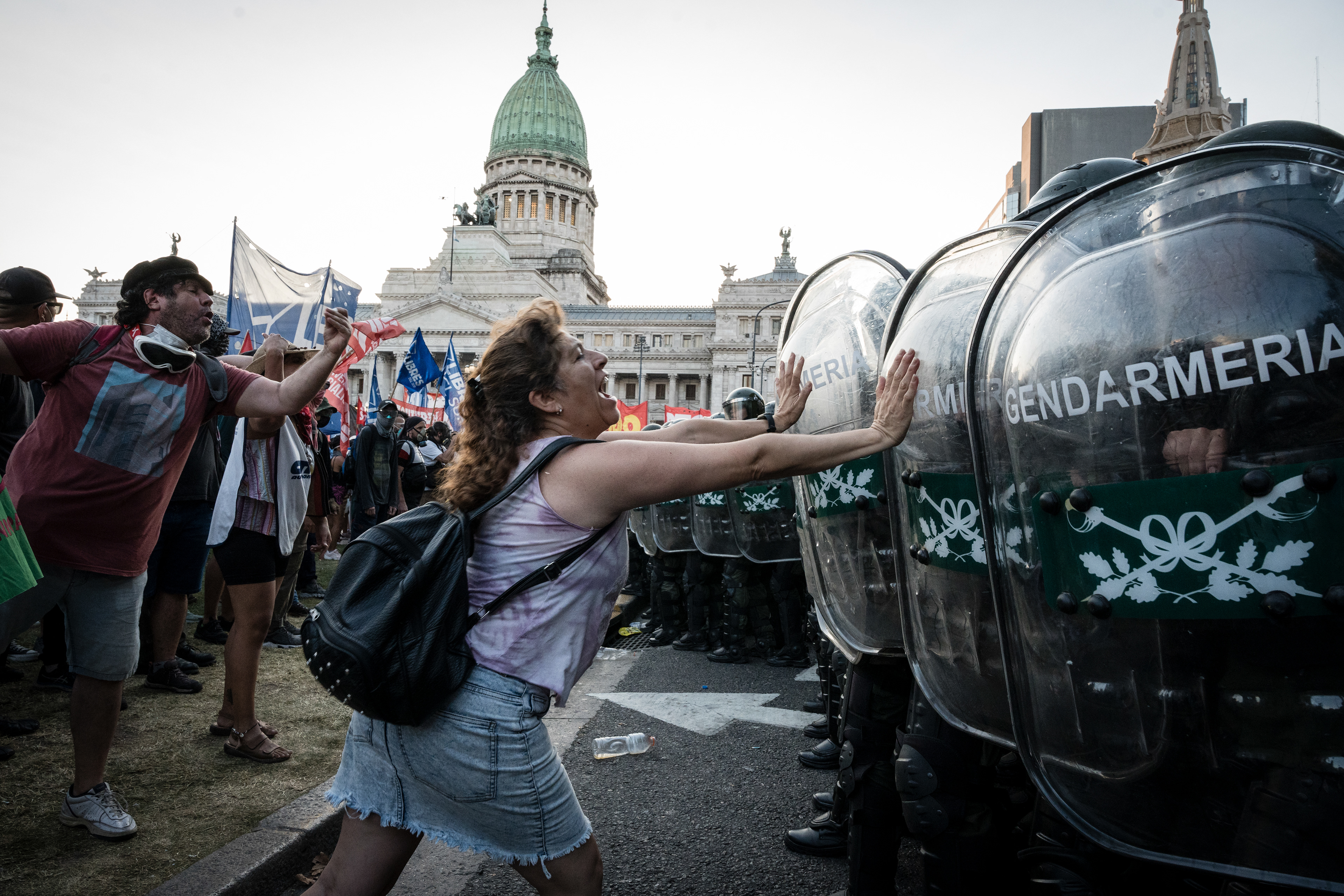 A woman stops with her arms the advance of the Gendarmerie in front of the protesters while the second day of debate in the National Congress of the treatment of President Javier Milei's "Omnibus Law" takes place, in Buenos Aires, Argentina, on February 1, 2024. PHOTO: Santiago Oroz.