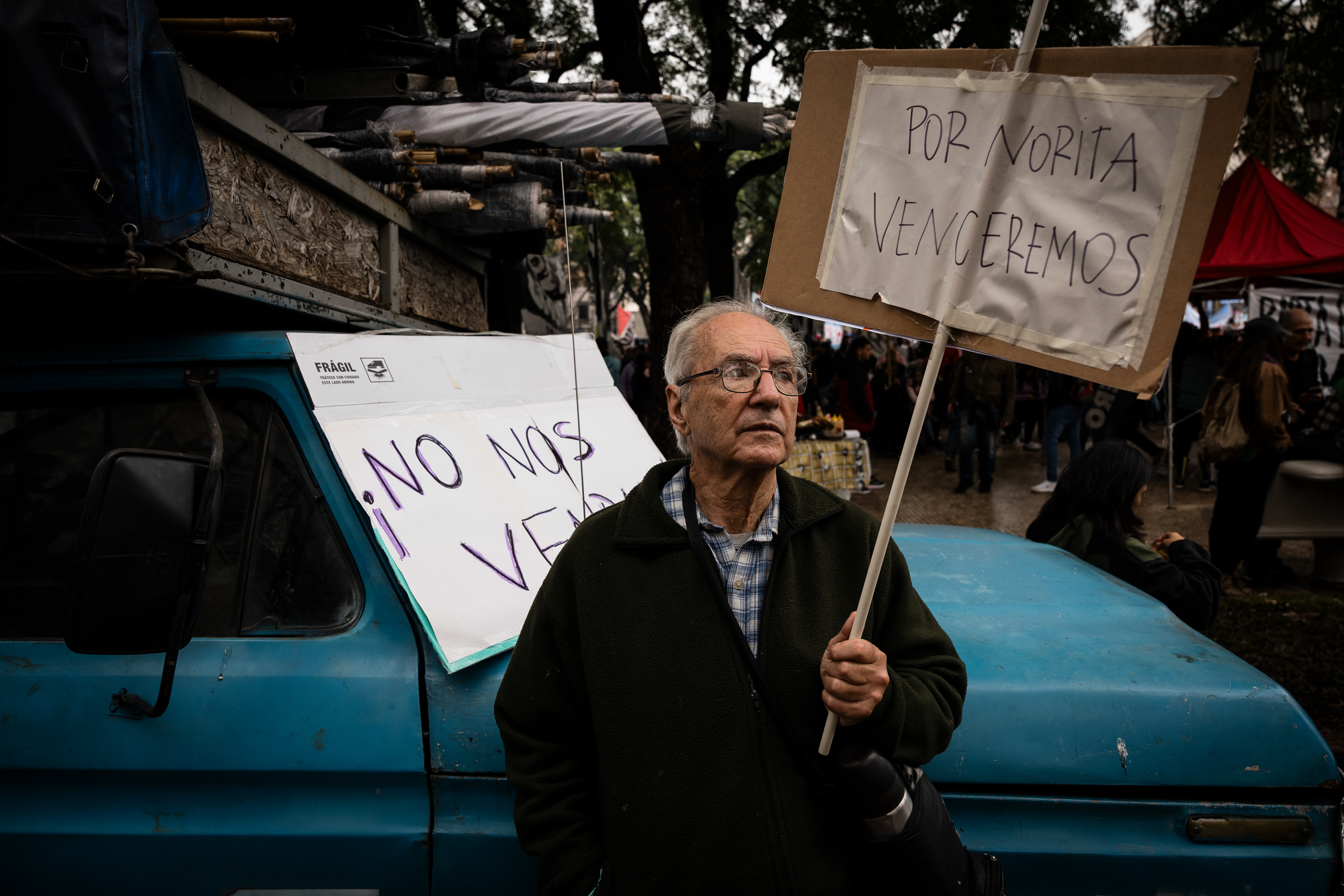 A demonstrator, holding a sign that reads "We will win with Norita" in reference to the recently deceased Mother of Plaza de Mayo Nora Cortiñas, protests outside while the Senate debates Javier Milei's Ley Bases. The Senate Chamber of the Argentine Congress is debating Javier Milei's Ley Bases, which has already passed the Chamber of Deputies. Meanwhile, hundreds of thousands of demonstrators are protesting in the streets, leading to confrontations and repressive actions by security forces, in Buenos Aires, Argentina, on June 12, 2024. PHOTO: Santiago Oroz
