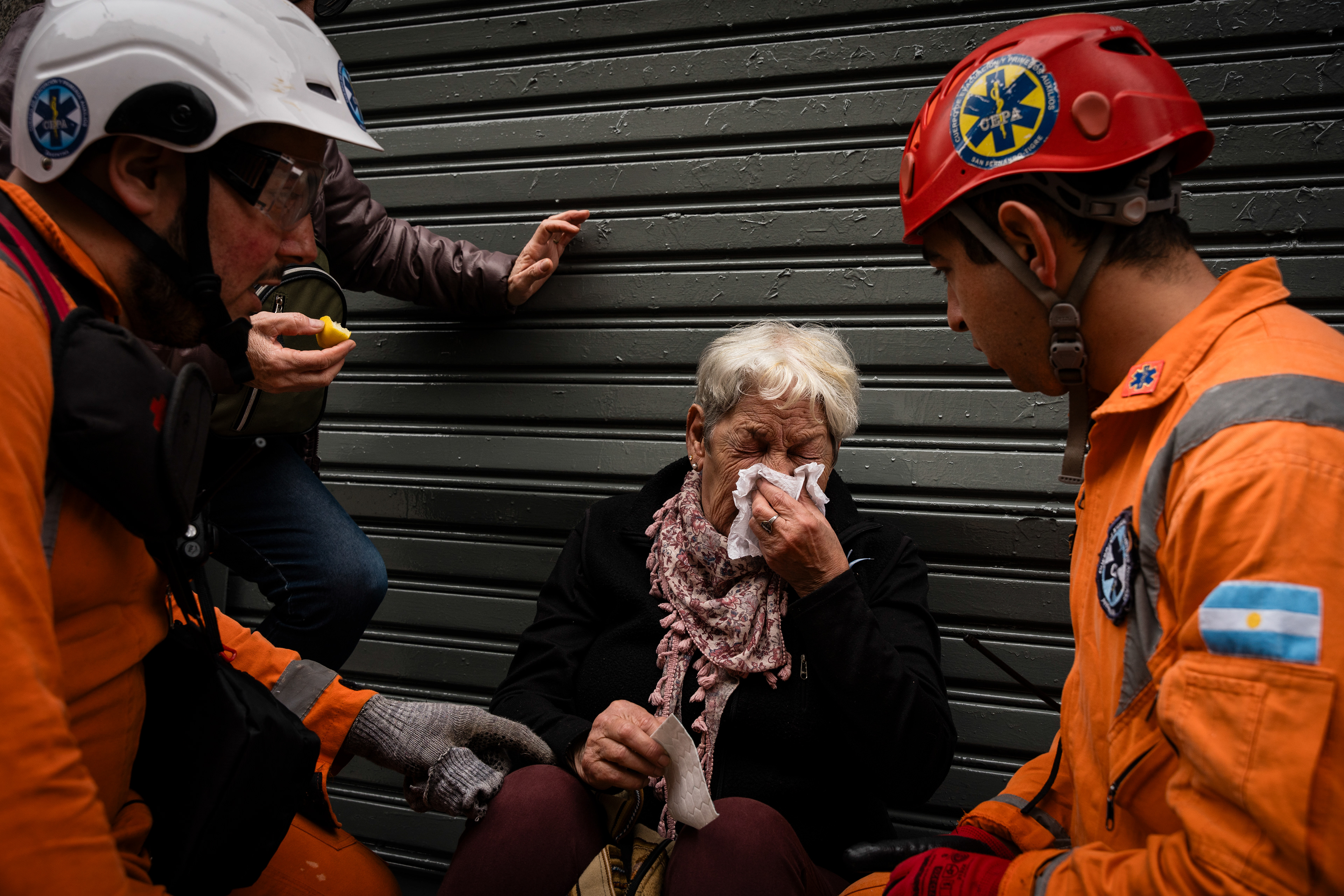 A woman is treated by medics after being pepper sprayed in the face by police during their protest outside while the Senate debates Javier Milei's Ley Bases. The Senate Chamber of the Argentine Congress is debating Javier Milei's Ley Bases, which has already passed the Chamber of Deputies. Meanwhile, hundreds of thousands of demonstrators are protesting in the streets, leading to confrontations and repressive actions by security forces, in Buenos Aires, Argentina, on June 12, 2024. PHOTO: Santiago Oroz
