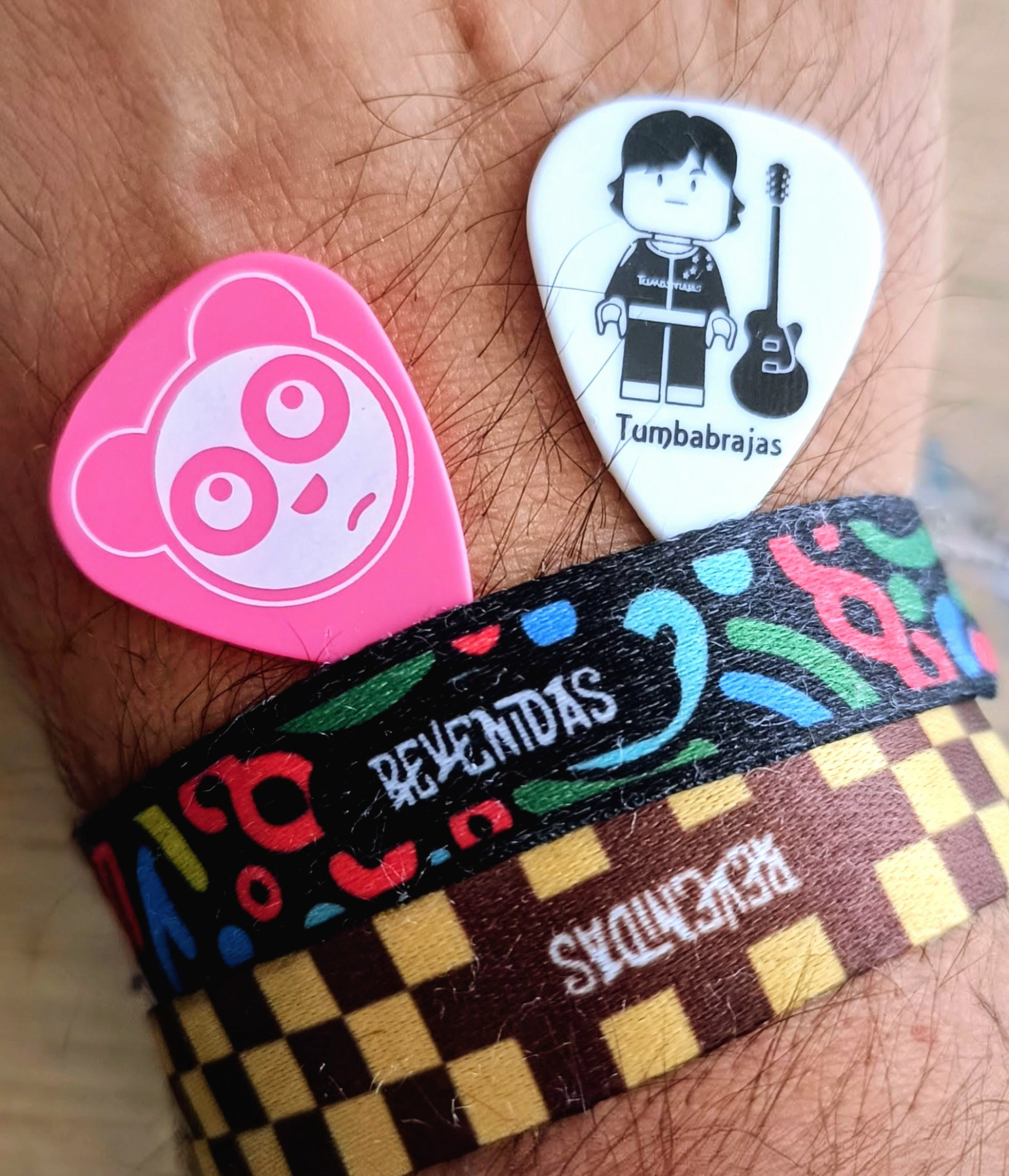 Pulseiras e púas do festival Revenidas 2025.