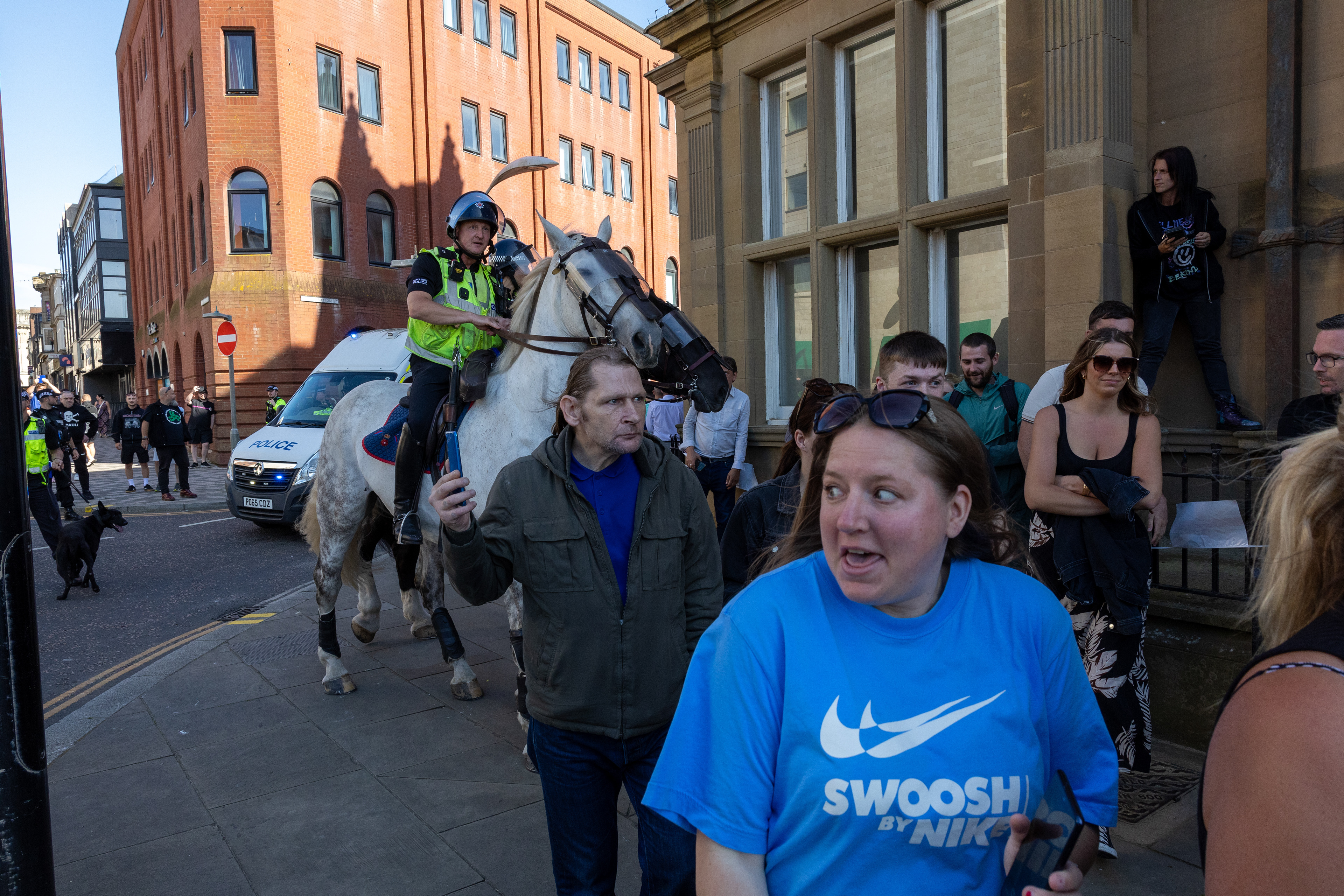 People run from police horses near Blackpool town hall on August 3 2024