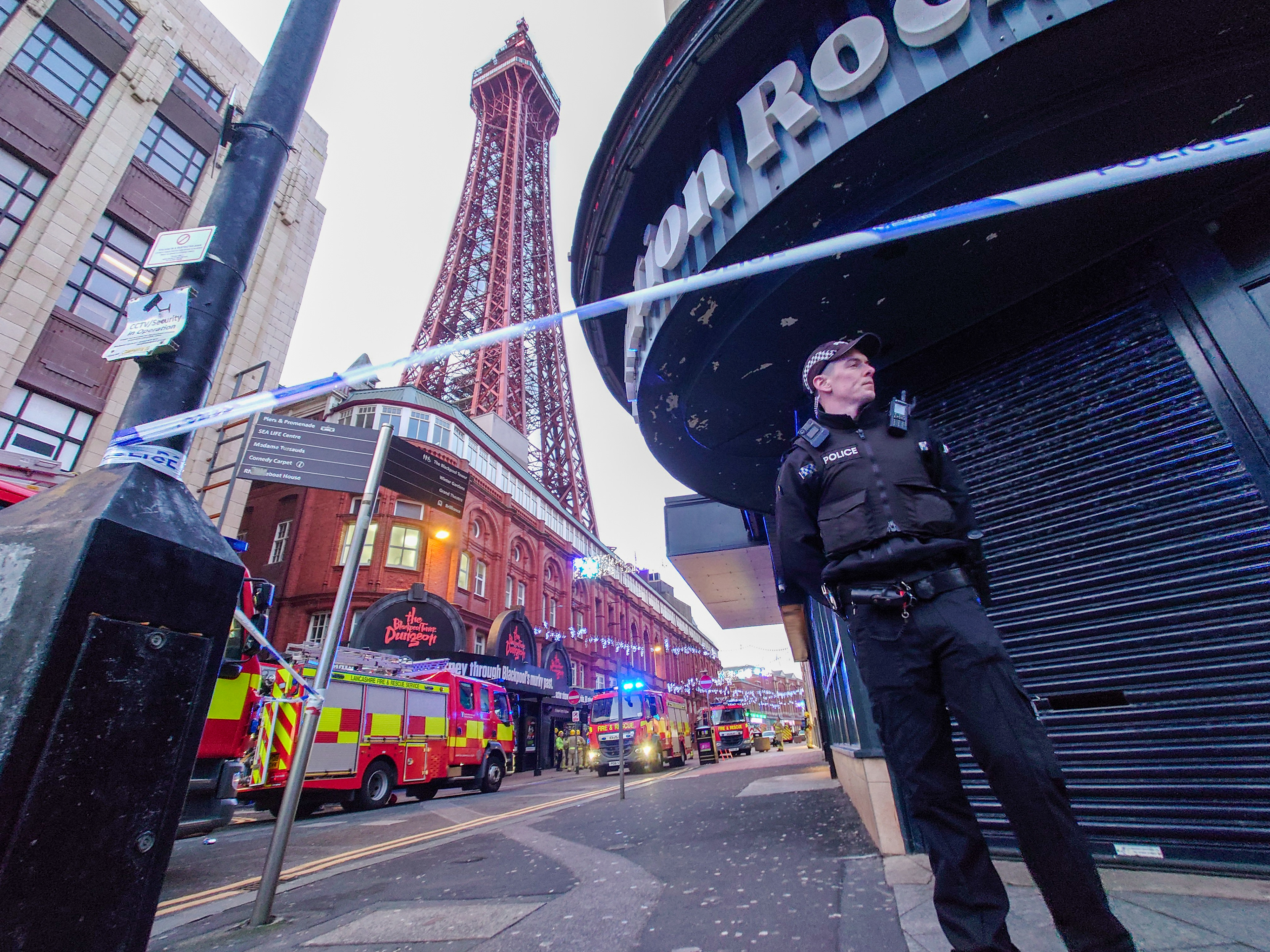 A police officer near Blackpool Tower during a false fire alert sparked by orange netting flapping in the wind