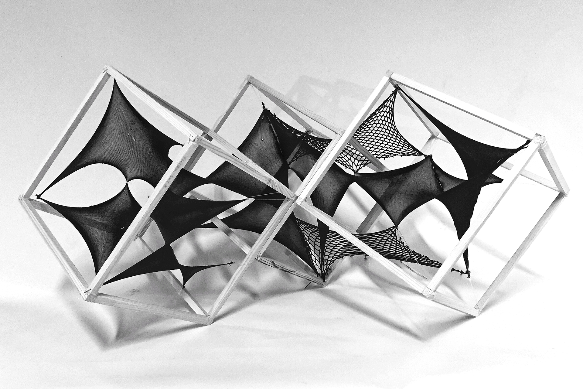 Material Void - material: textile pieces of different permeability, fishing line | frame: wooden sticks, nails