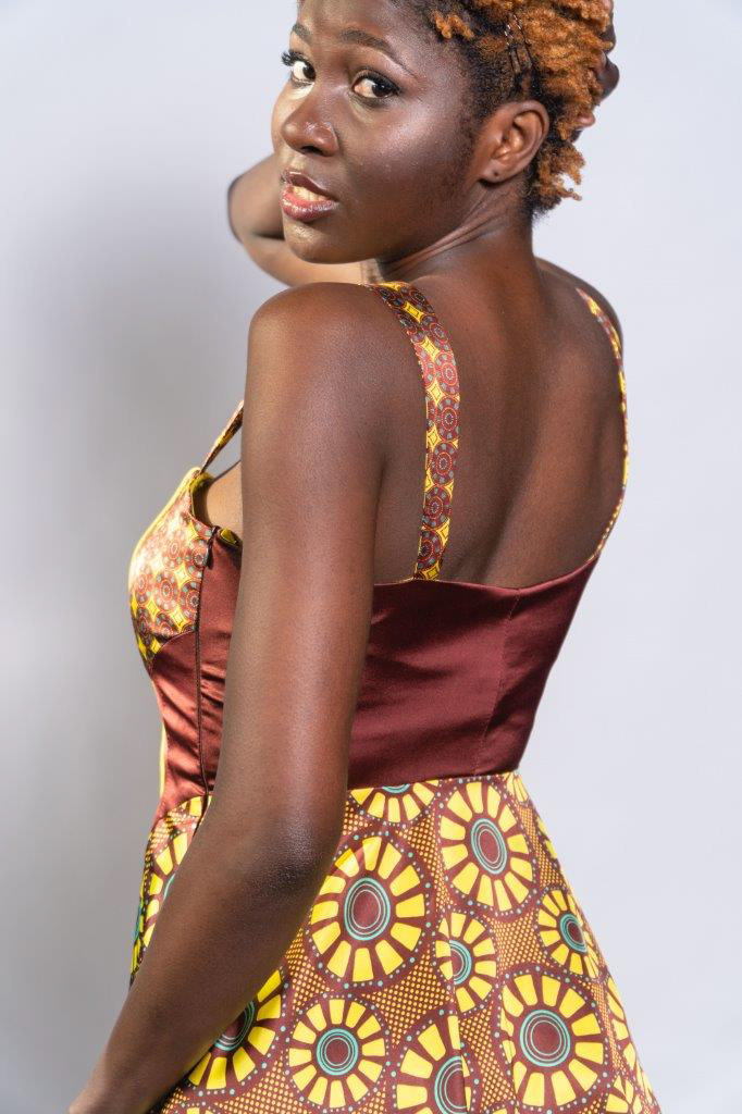detalle parte superior espalda de vestido estampado con diseños de inspiración africana coordinados, en colores bordeaux, amarillo y turquesa