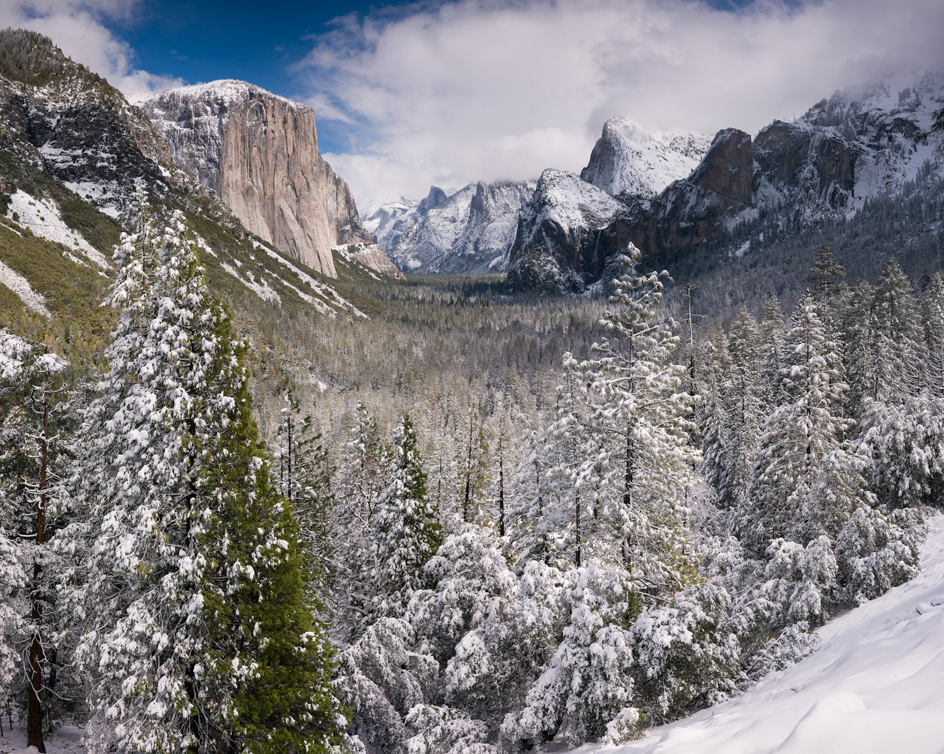 The classic view of Yosemite Valley from Tunnel View after a large snowfall. This photograph is made up from 8 different photographs that have been stitched together.