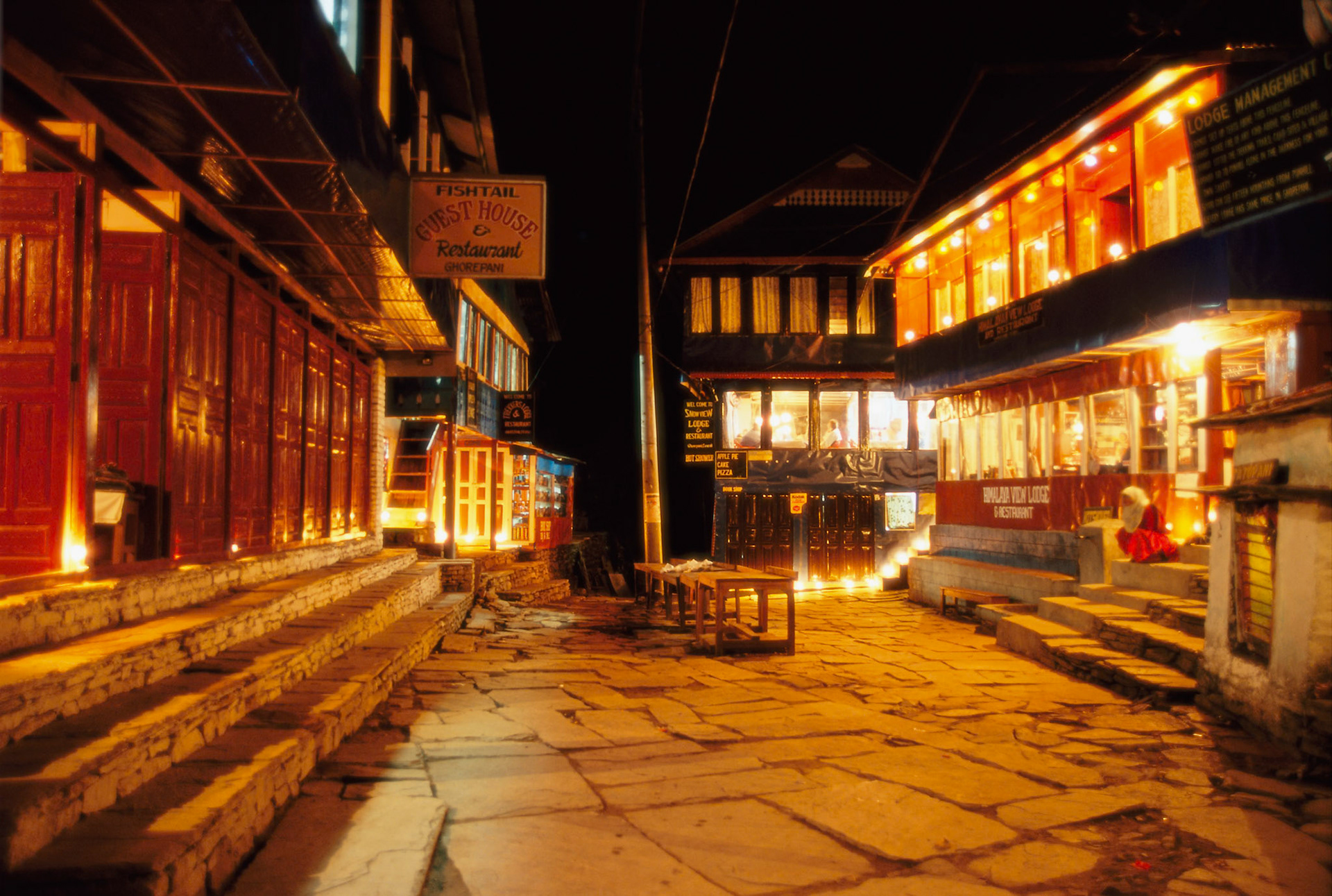 During the Tihar festival (festival of lights), it is traditional for the Nepalis to place candles outside their homes to welcome Laxmi, the Goddess of Wealth. Ghorepani has hydro-electric power and the electric street and lodge lights overwhelmed the candlelight. However there was a sudden power cut, and the locals lit parafin lamps in the lodges. I went outside with my F100 and tripod and took this photo before the electricty was restored.