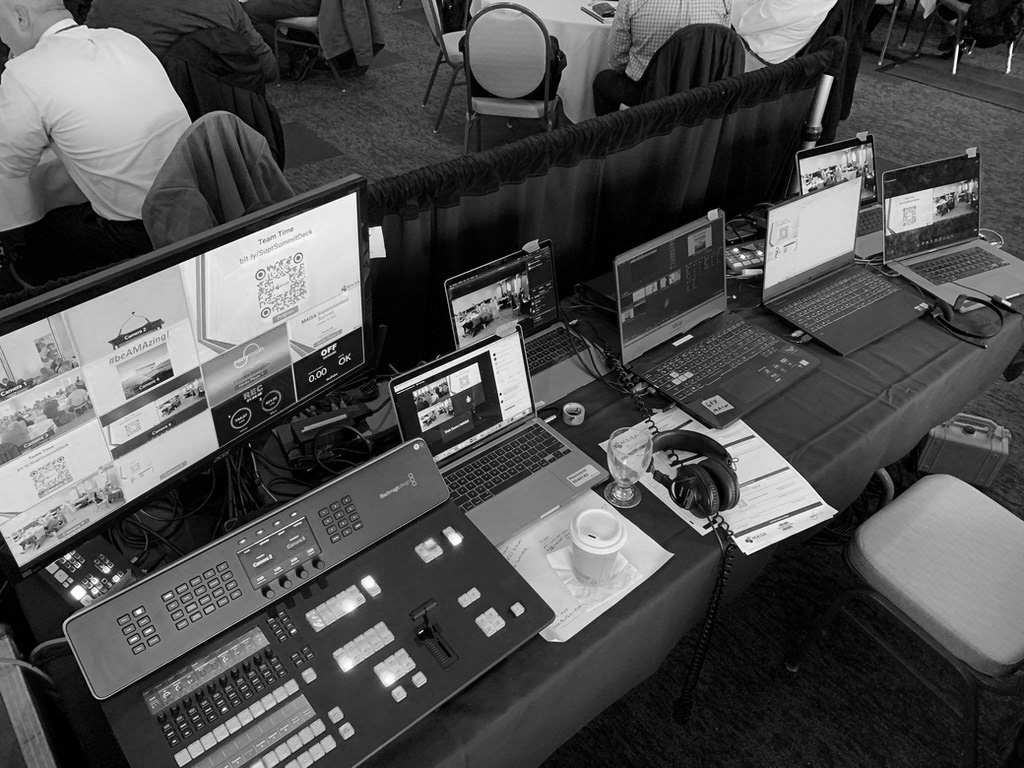 Front of house setup for a hybrid education conference. (2023)