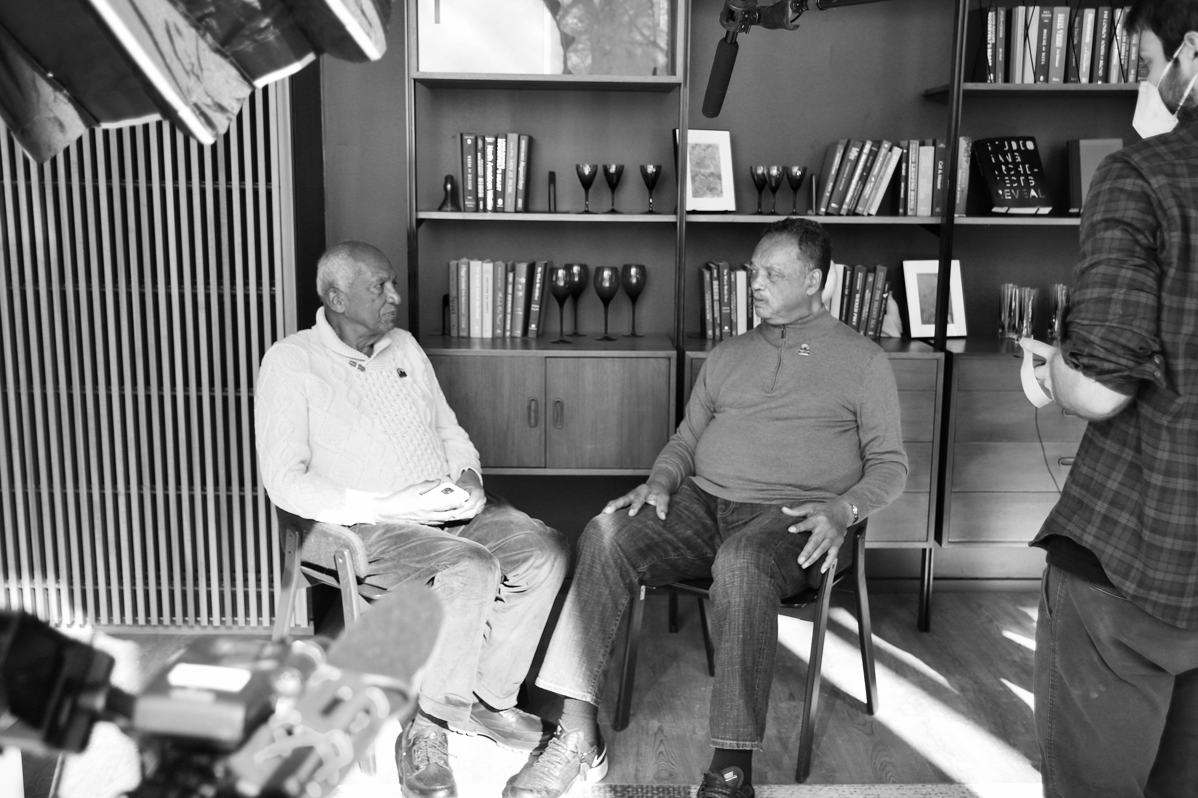 Setting up interview between Joel Ferguson and Rev. Jesse Jackson. Photo by Tina Miller. (2022)