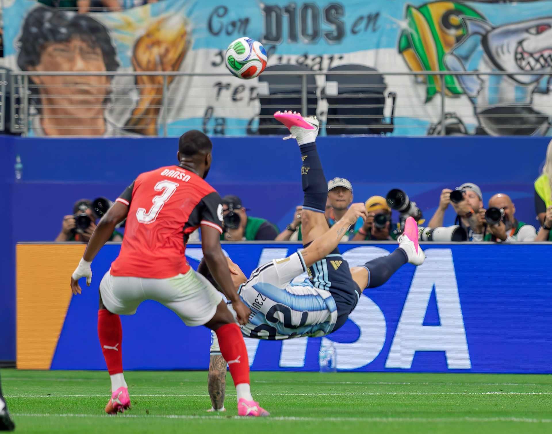 Argentinian striker Lautaro Martinez bicycle kicking the ball back to teammates. 