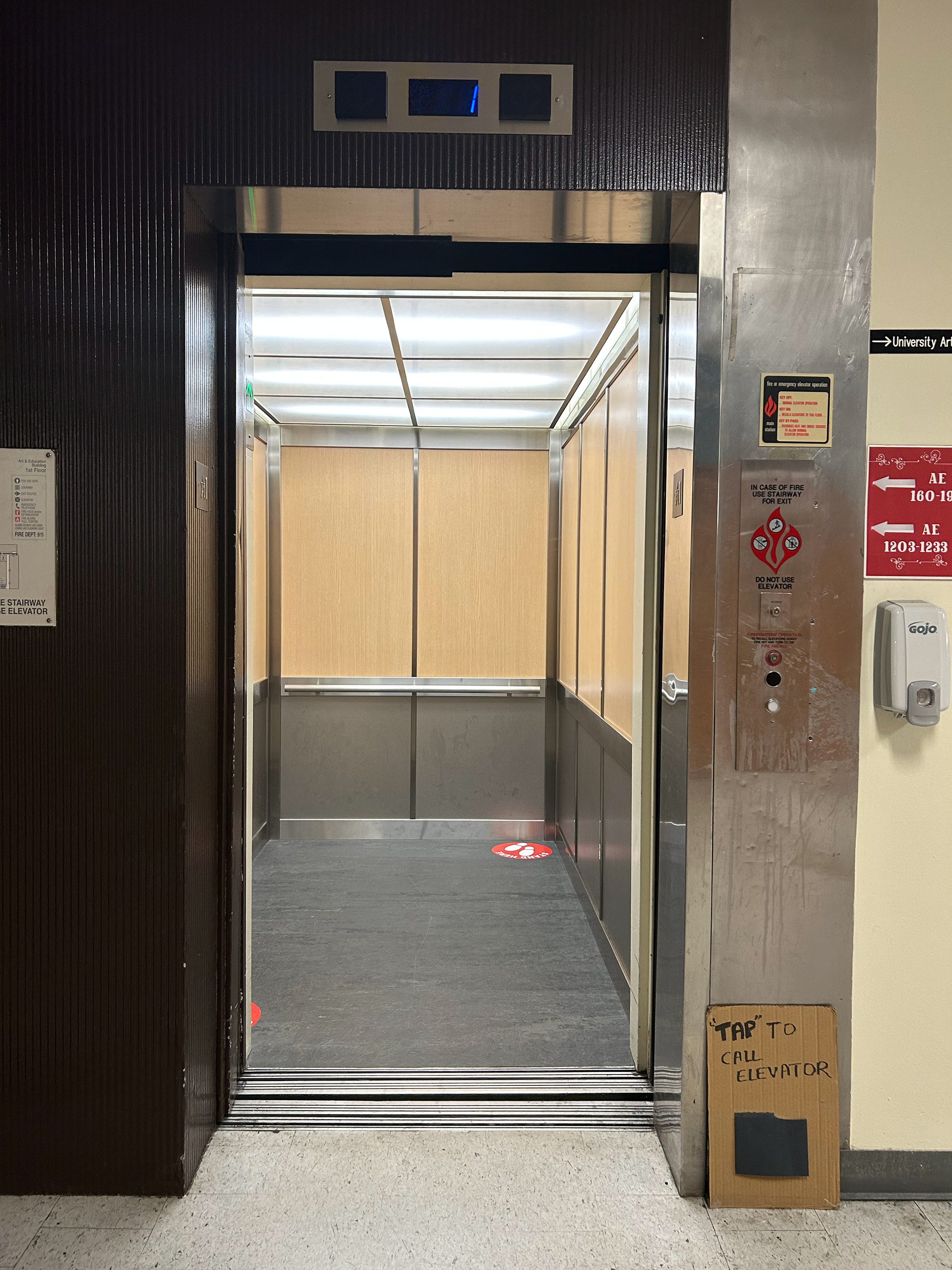 open elevator after the user taps on the sign with foot