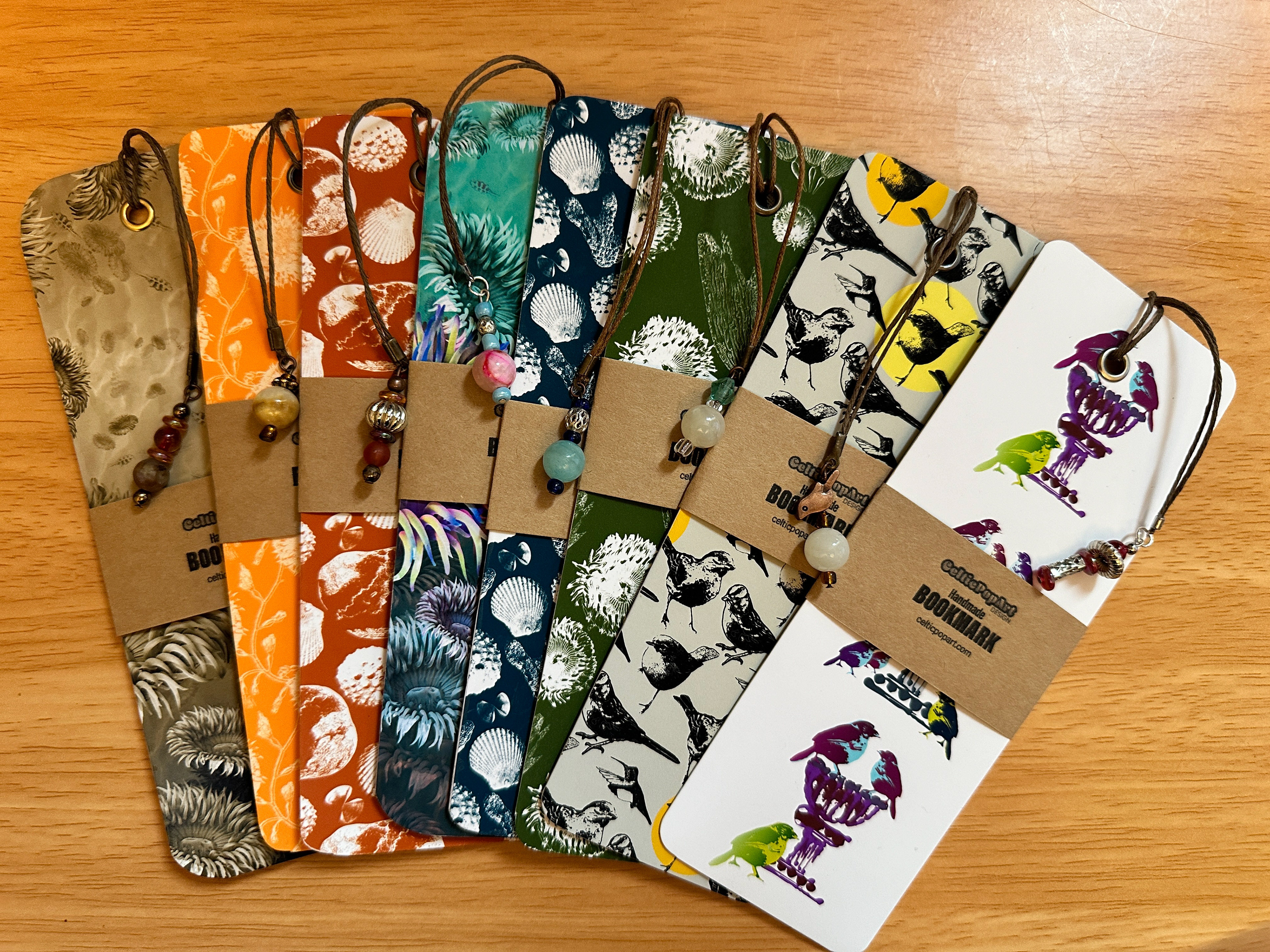 display of vibrantly patterned bookmarks with beaded tassels, labeled CelticPopArt Bookmarks.