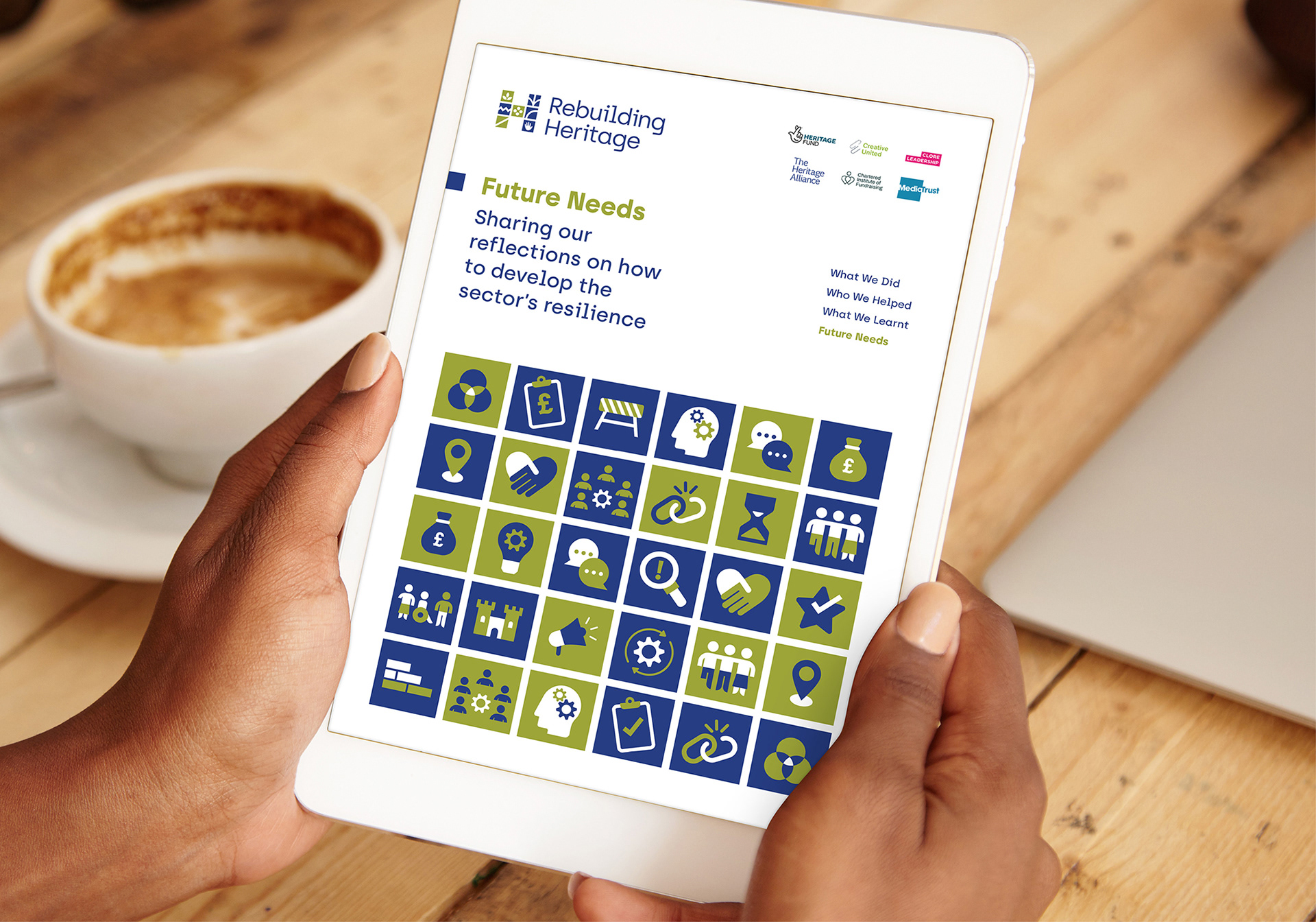 An iPad showing the cover design for Rebuilding Heritage's Infographic designed by Sharon Armstrong Creative