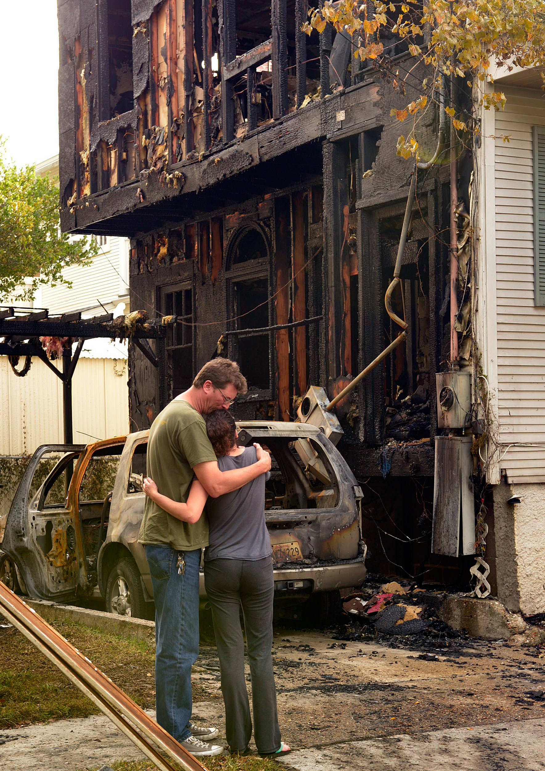  Mark Brown and Erica Centurion embrace in front of the burned out apartment they lived in on Prytania Street. The house and three cars burned on Prytania Street at Constantinople in the early morning hours Thursday, November 6, 2014 after an apparent fire bombing.