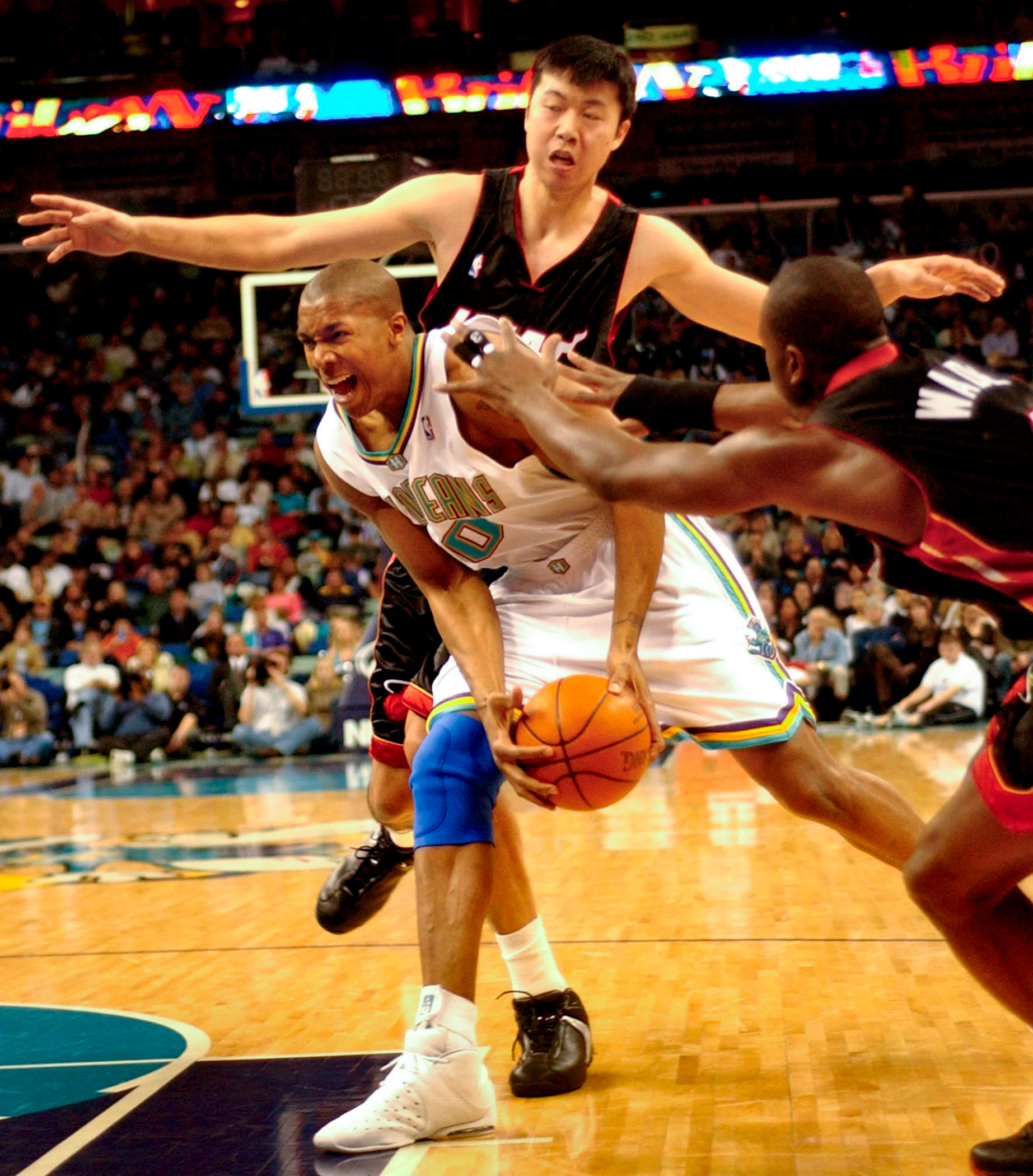 David West is double teamed by Miami's Wang Zhi-zhi and Dwayne Wade in the first half.Hornet Sean Marks defends against Nugget J.R. Smith in the first quarter in NBA playoff action at the New Orleans Arena Saturday