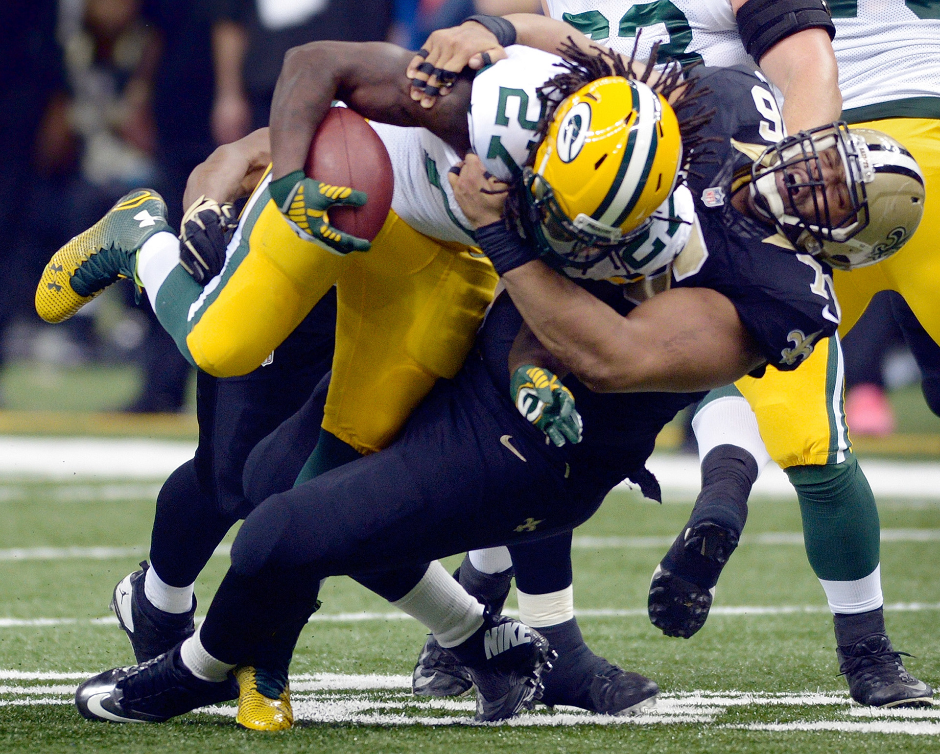 Green Bay Packers running back Eddie Lacy (27) is brought down by New Orleans Saints defensive end Akiem Hicks (76) in the first quarter as the New Orleans Saints faced the Green Bay Packers Sunday,