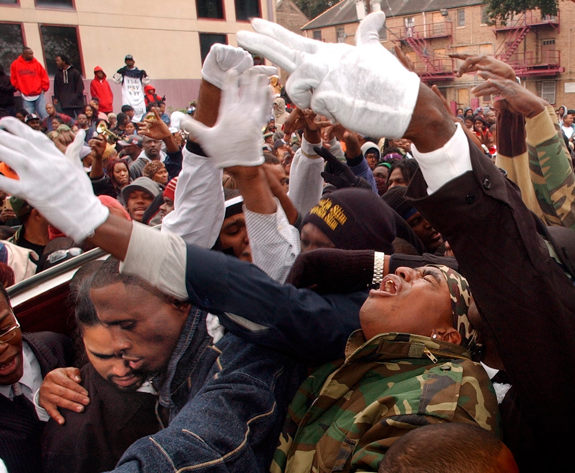 Mourners wail as Soulja Slim's casket in placed in a hearse on Washington Avenue next to the Magnolia housing project where Slim grew up. Rapper James Tapp, known as Soulja Slim and Magnolia Slim, was murdered last week. His funeral featured brass band, horse drawn hearse and hundreds of mourners who wore tee-shirts, buttons and camouflage in his honor..