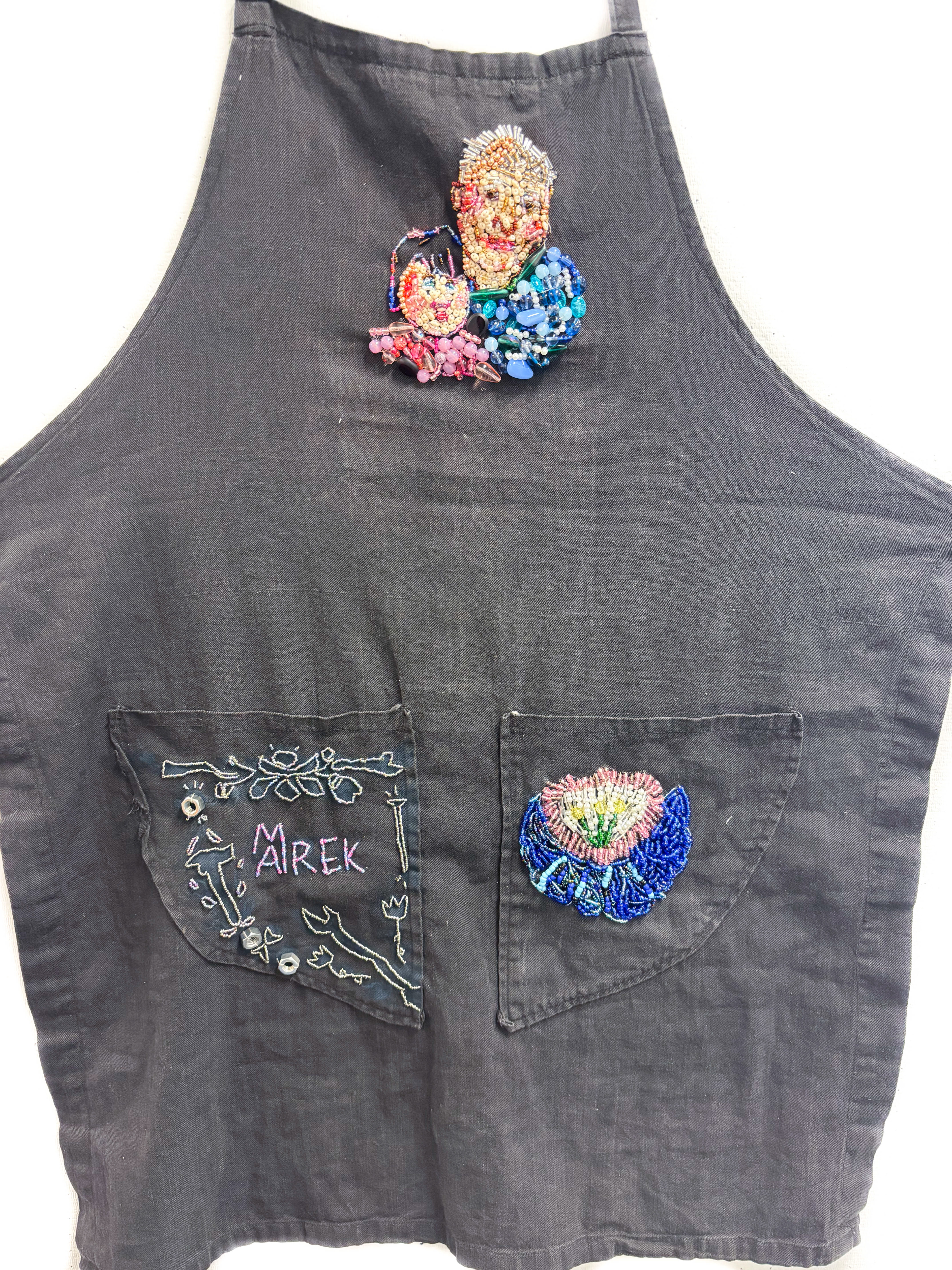 "Grandpa's Memorial Apron"  2025, beading and screen printing on Grandfather's apron