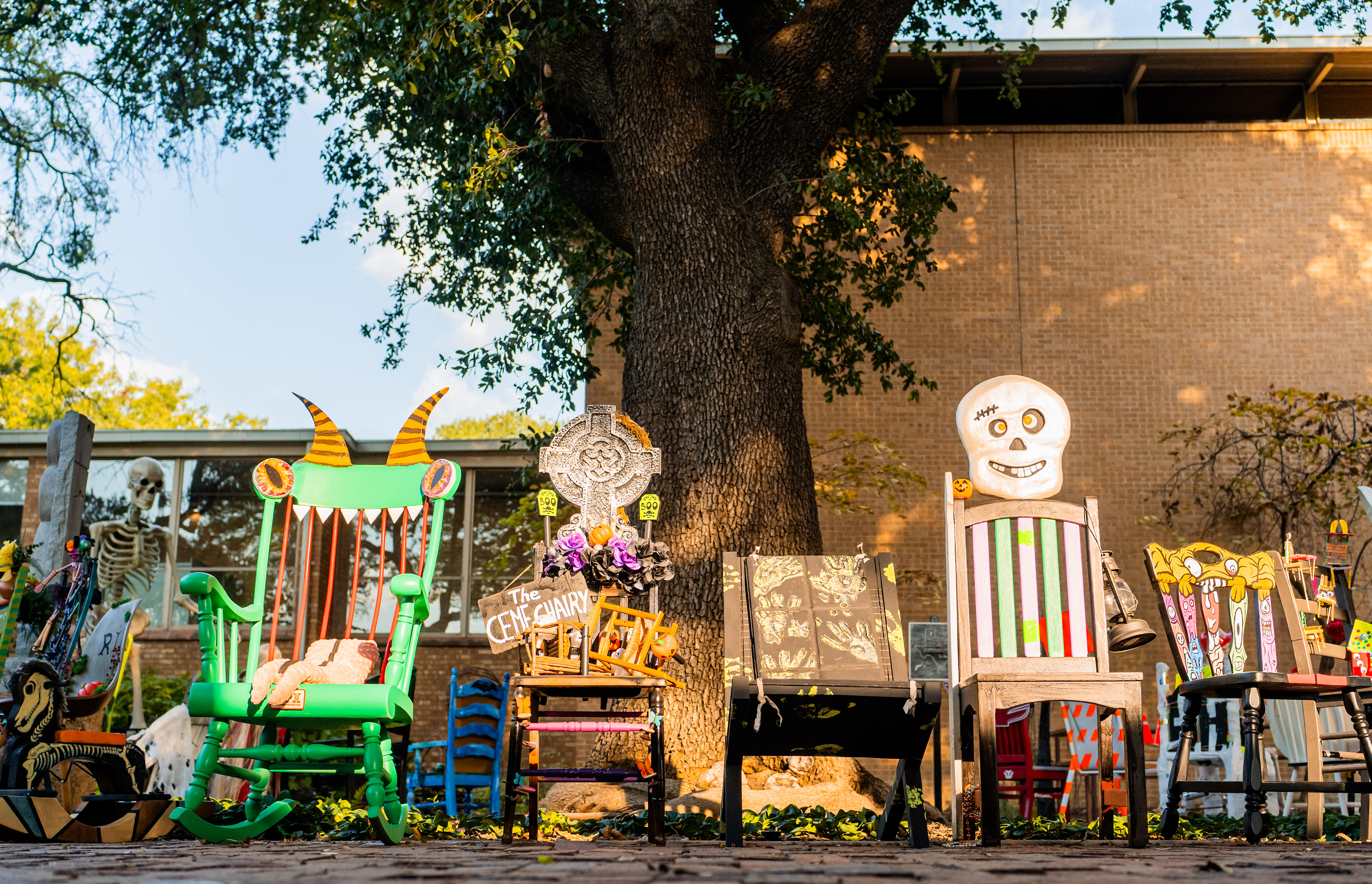 The Chairs Lined Up: The “Ceme Chairy” chair with other chairs at the Scary Chairy Orchard ongoing exhibit near Denton City Hall on Oct. 11, 2024