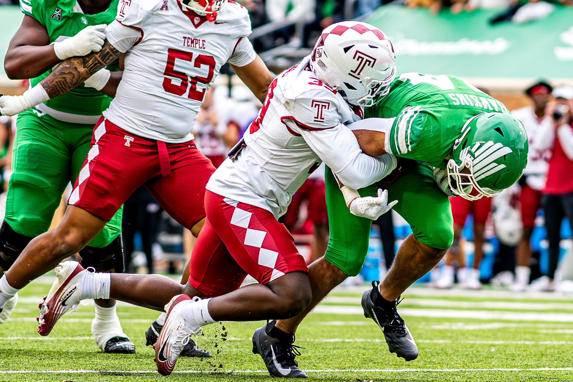 Freshman running back Caleb Hawkins gets tackled by a defender against Temple at DATCU Stadium in Denton, TX on Nov. 28, 2025.