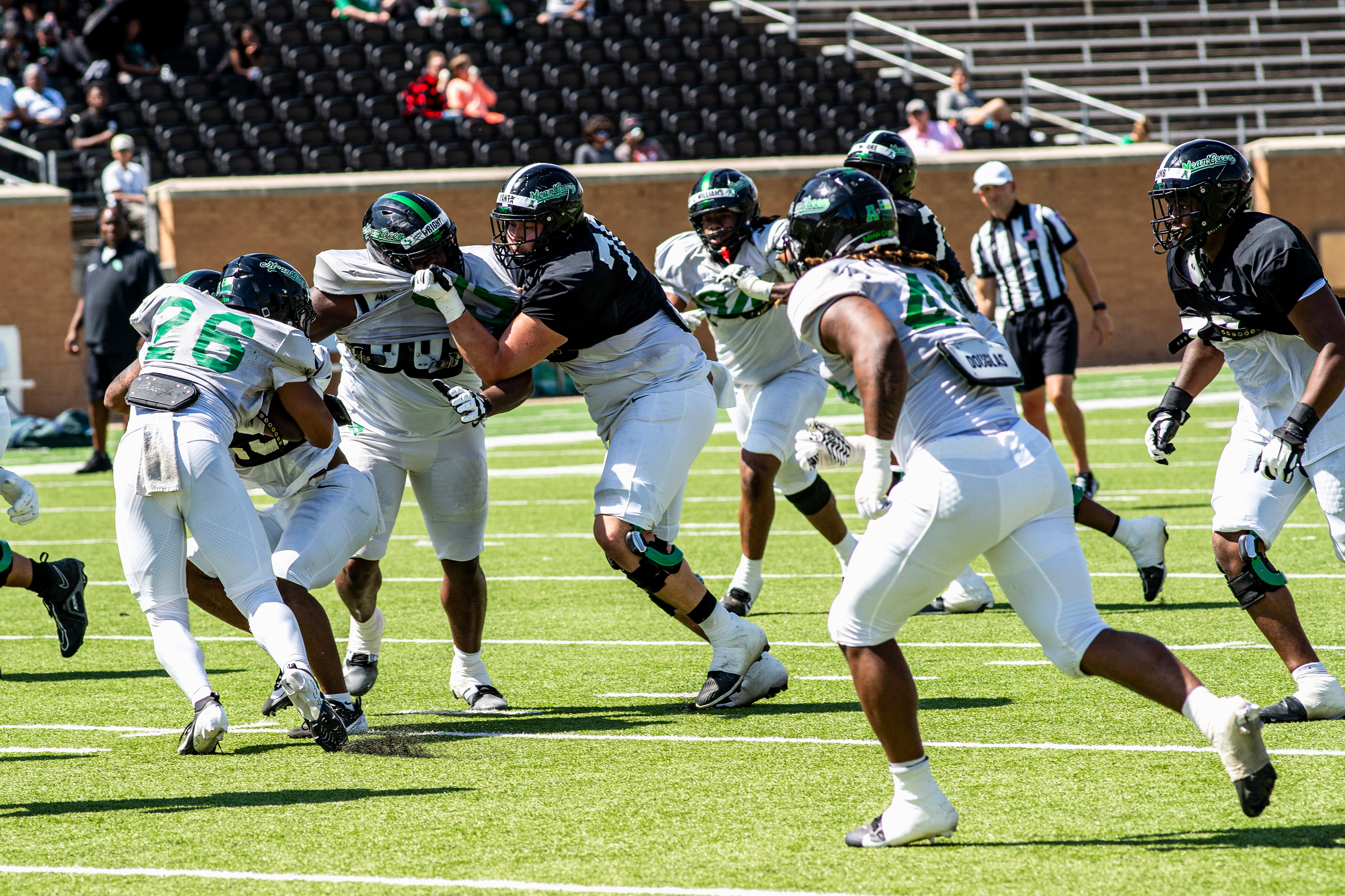 Stop the Run: Sophomore linebacker S'Maje Burrell tackles the ball carrier during UNT's scrimmage at DATCU Stadium.
