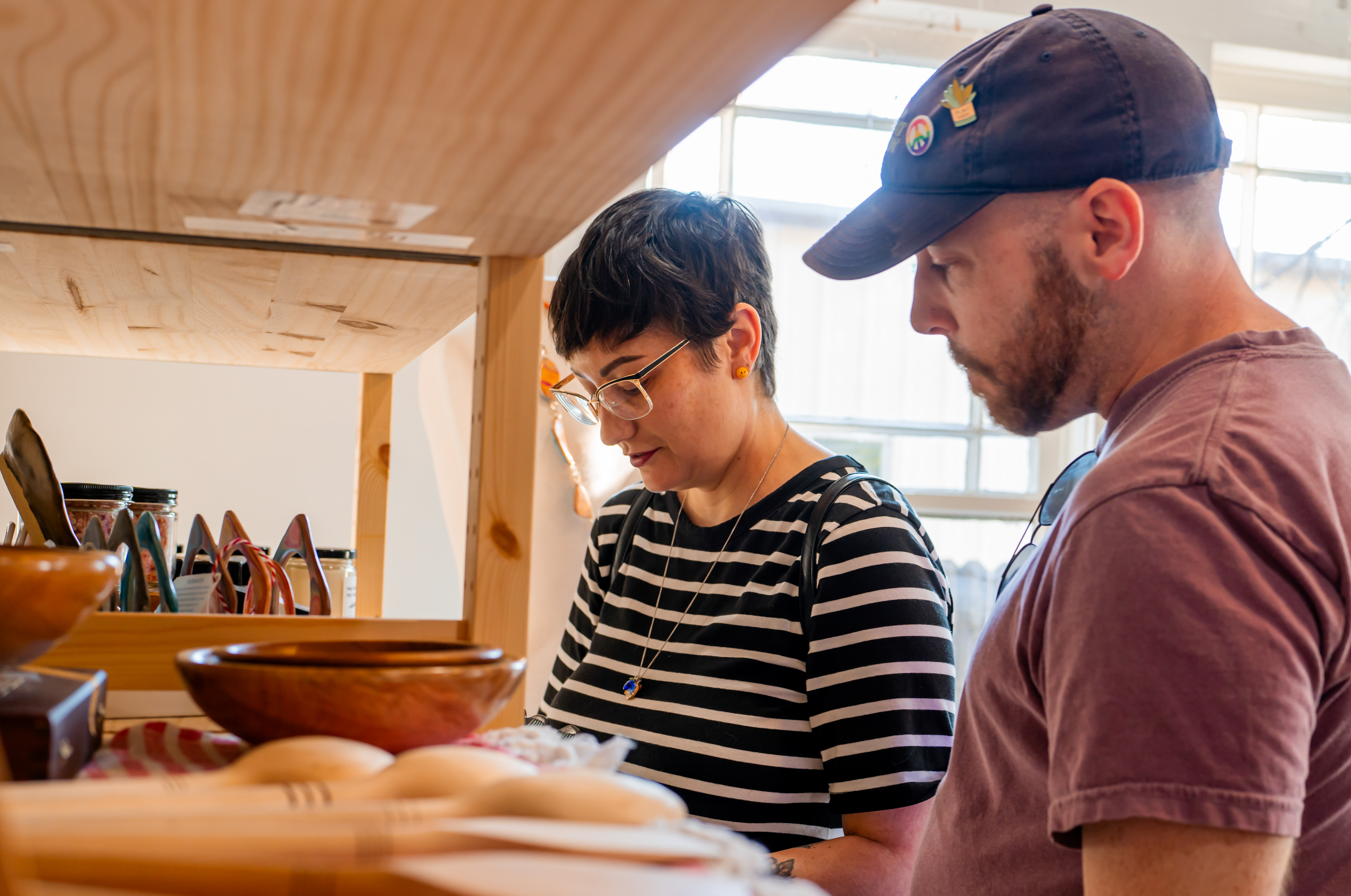 Jane and George: Jane LeBlanc and George Tuttle inspects items at the soft open and silent auction event at the Denton Maker Center on Oct. 5, 2024