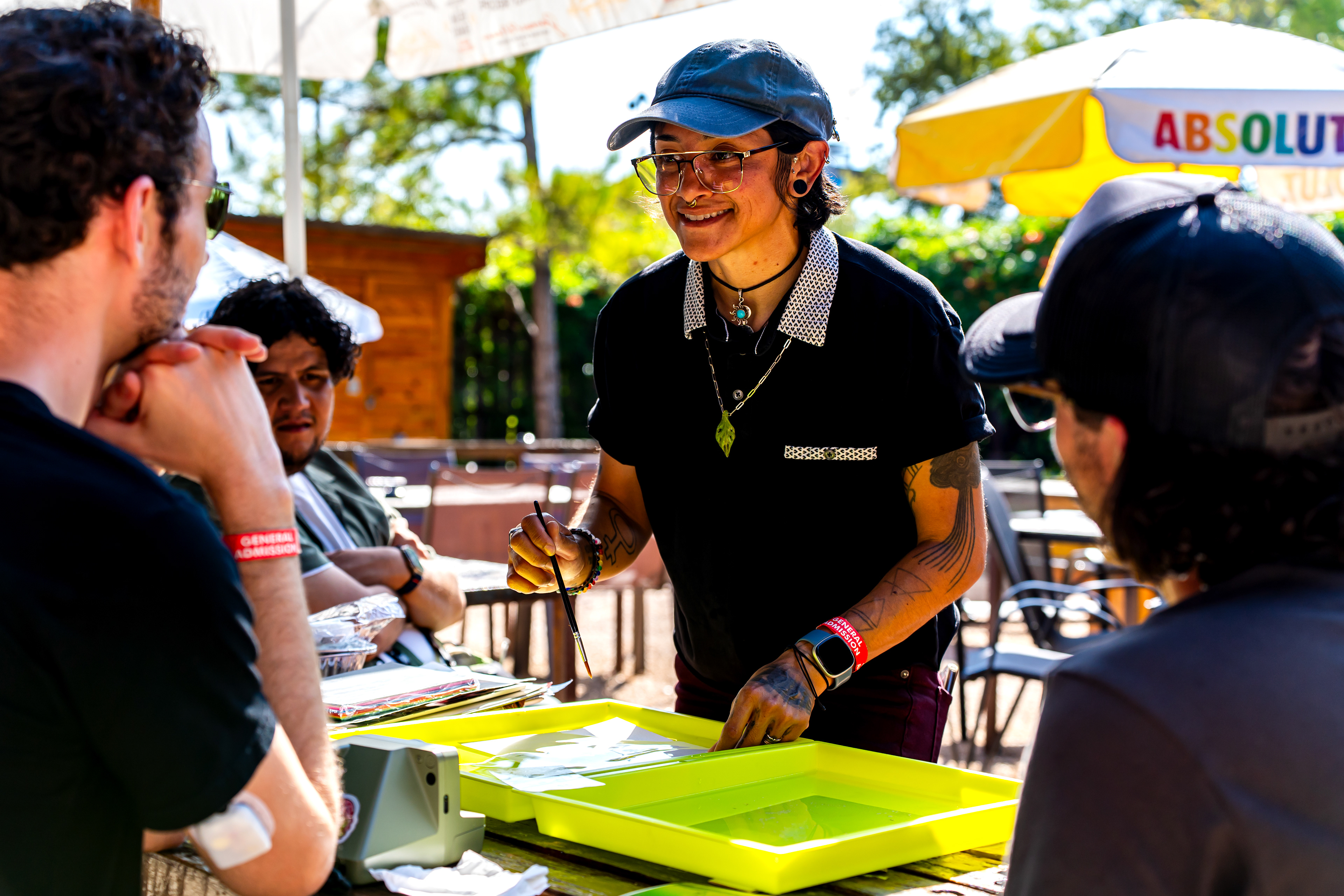 Renee Medina transfers the emulsion layer of a Polaroid to a different surface during her emulsion lift workshop at Harvest House during Polacon on Sept. 26, 2025.