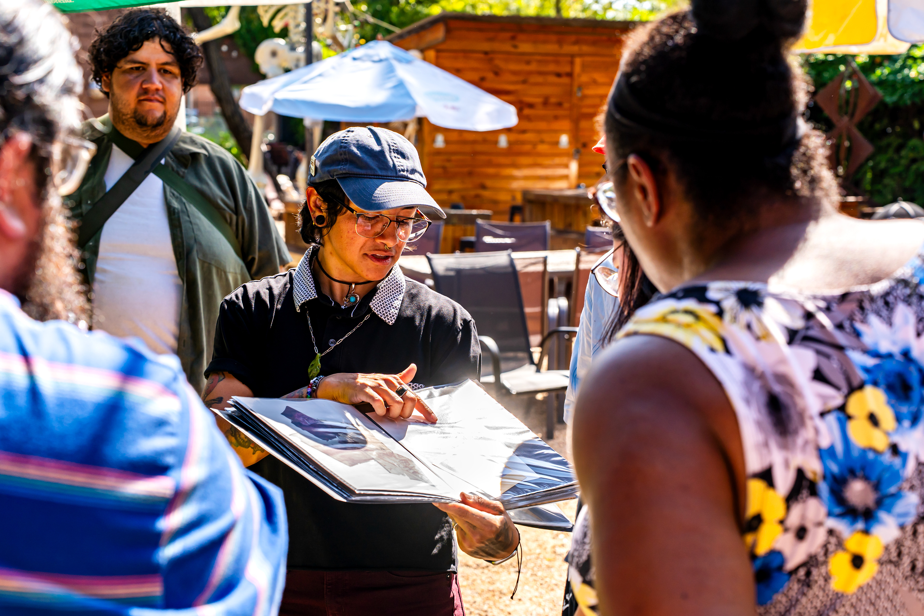 Renee Medina shows emulsion lifts to attendees during her emulsion lift workshop at Harvest House during Polacon on Sept. 26, 2025. 