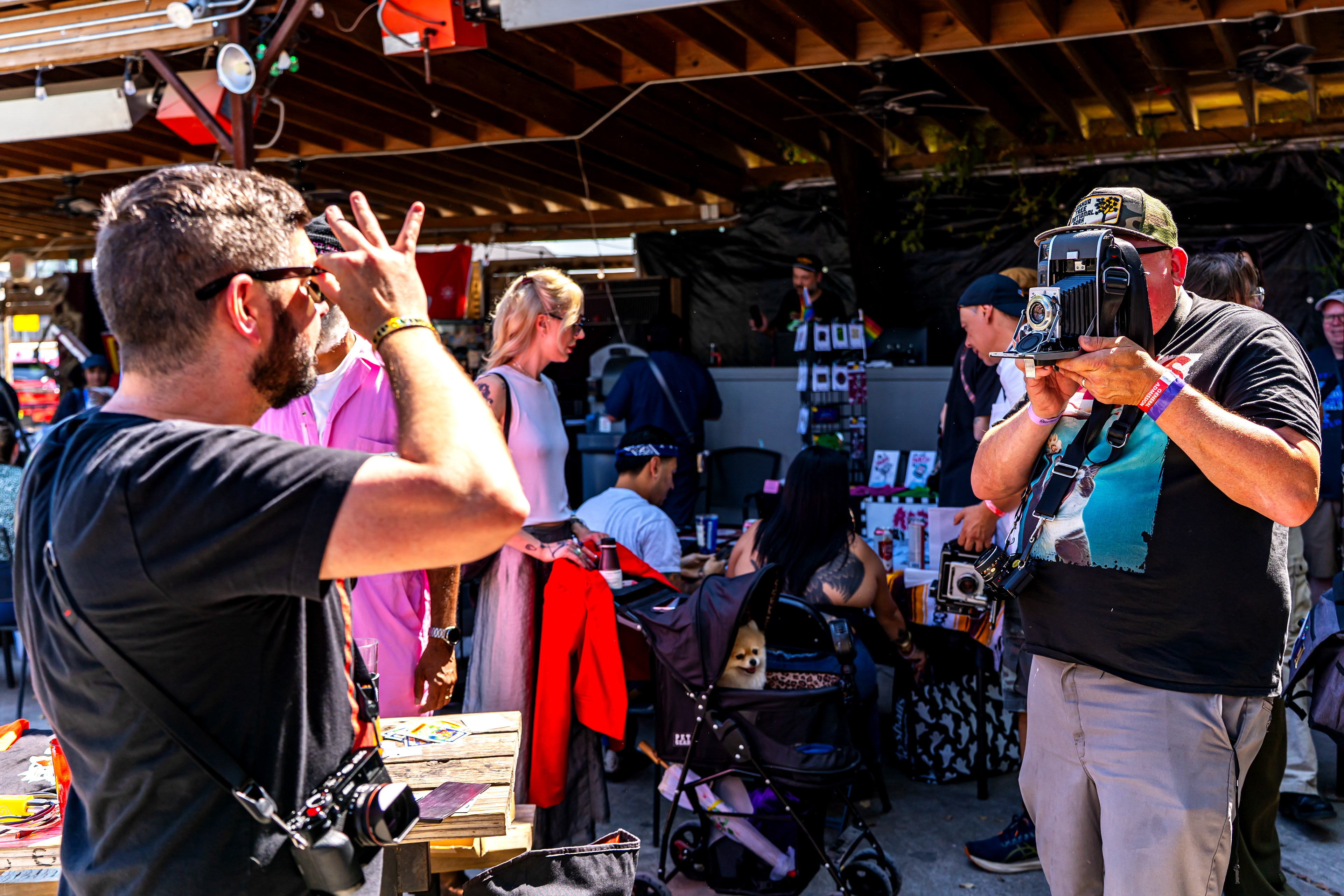 Attendee Jeremiah Blume takes a Polaroid with his Polaroid 110A camera at Rubber Globes during Polacon in Denton, TX on Sept. 27, 2025.