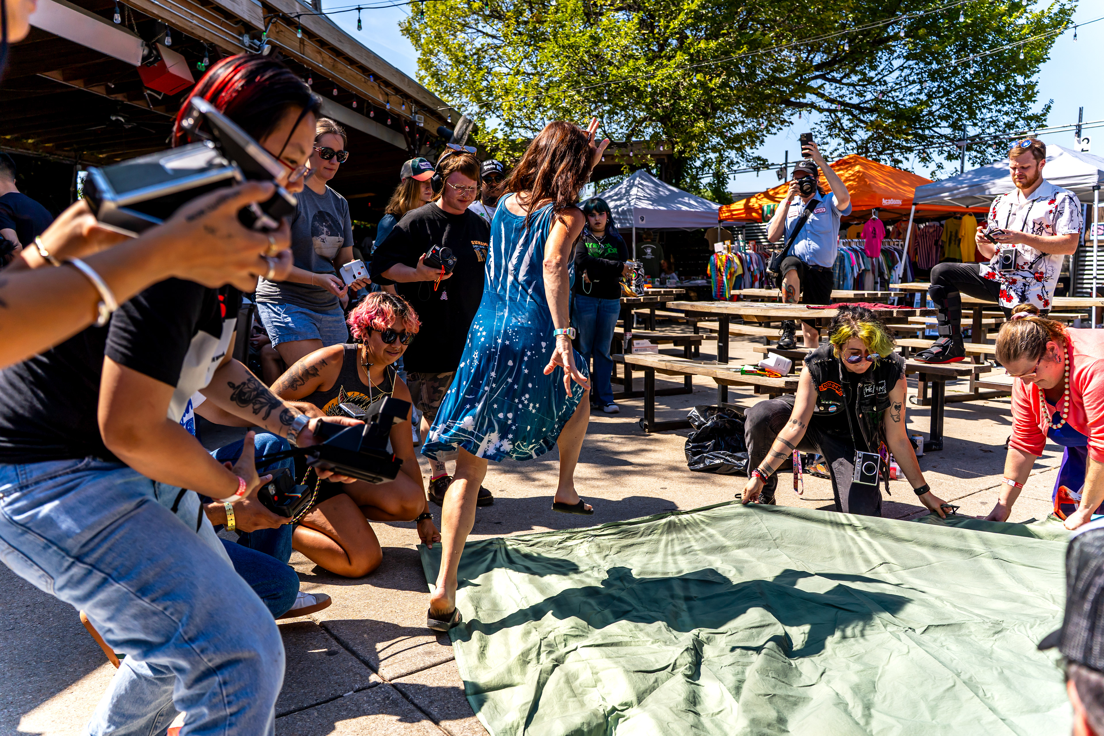 Amy Jasek instructs Polacon attendees before her large-scale cyanotype workshop at Rubber Gloves in Denton, TX The attendees on the cyanotype needed to run after it finished developing.