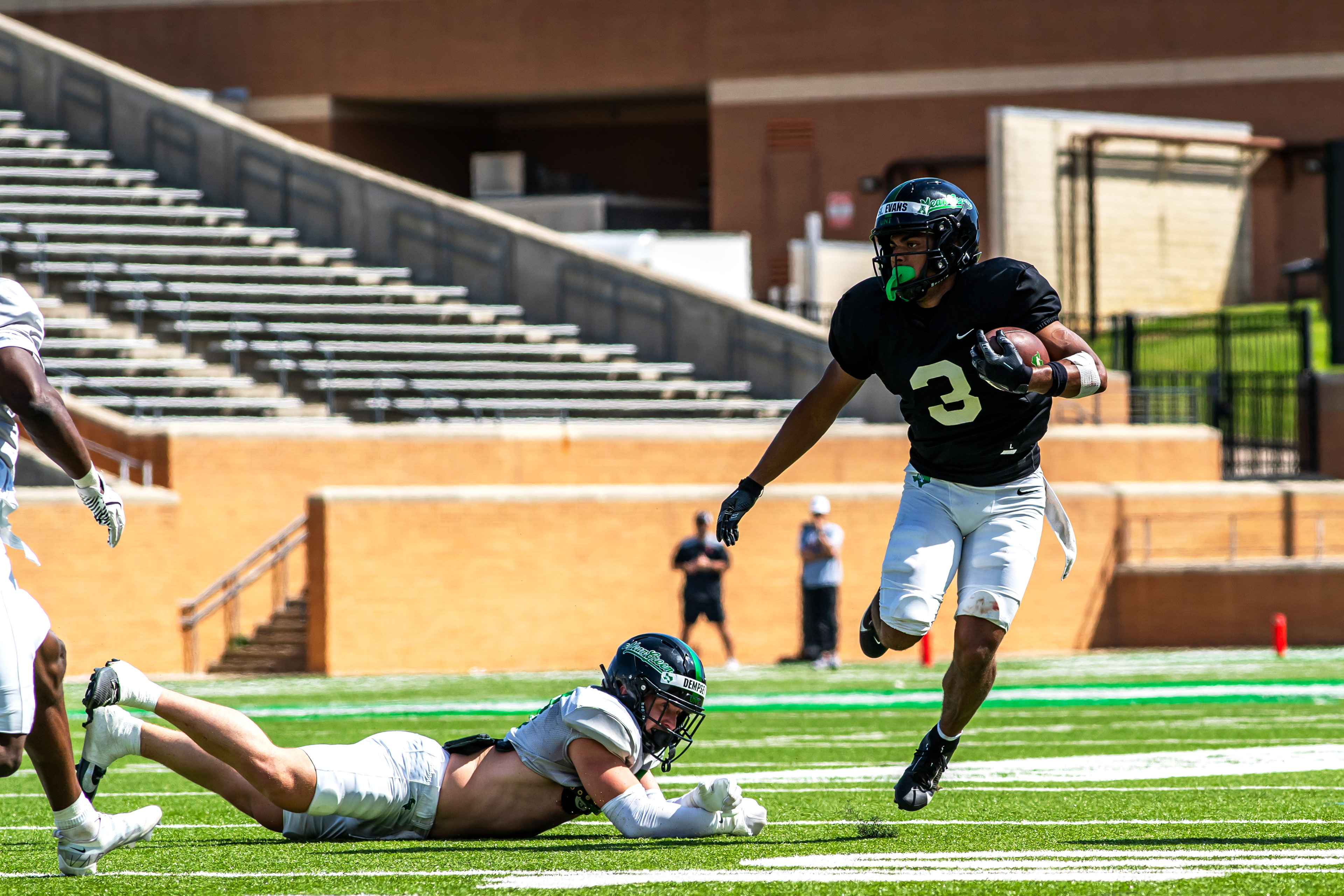 Simeon in the Open Field: Senior wide receiver Simeon Evans evades a defender during UNT's scrimmage at DATCU Stadium.