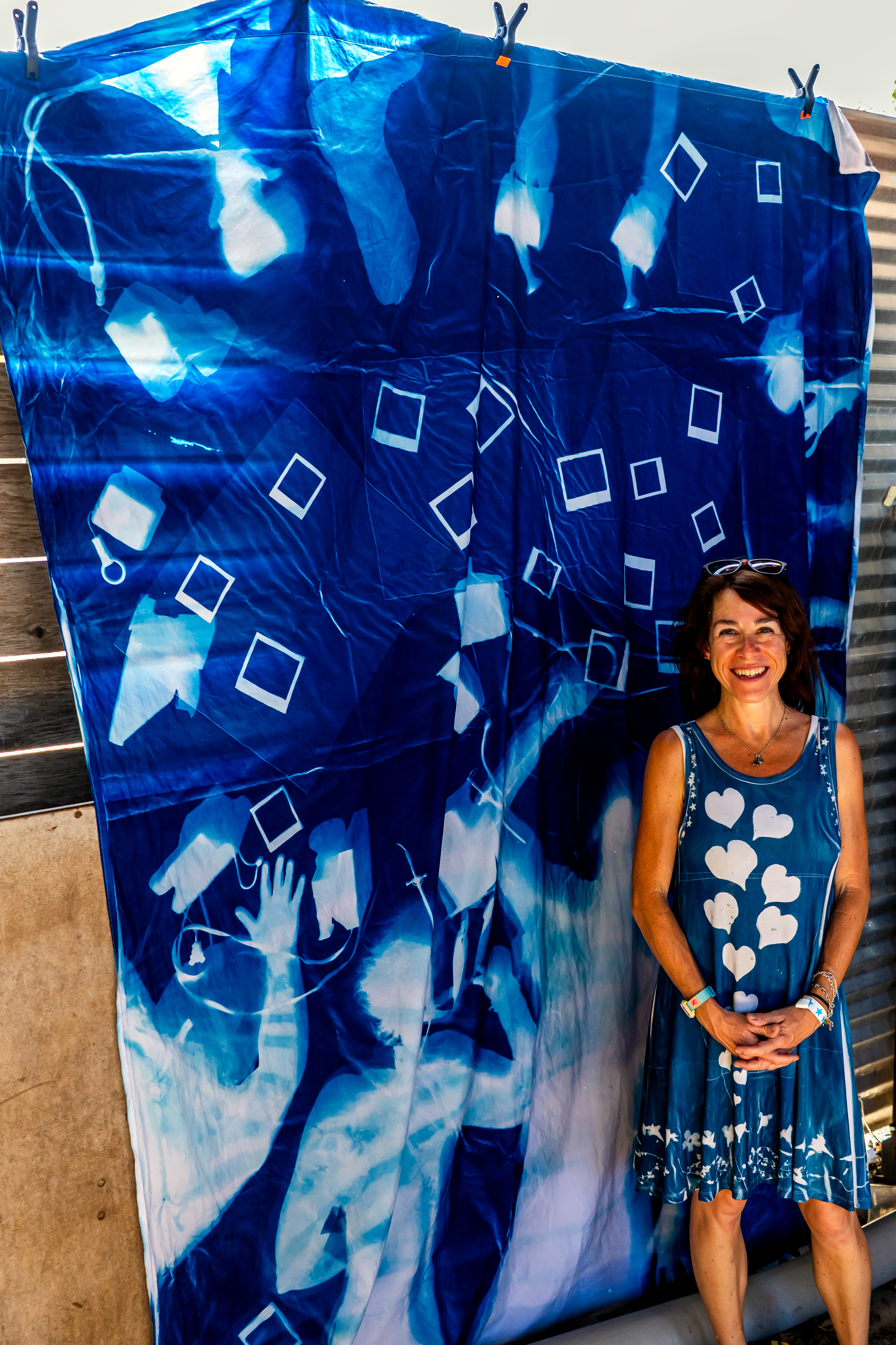 Amy Jasek poses with the finished large-scale cyanotype.