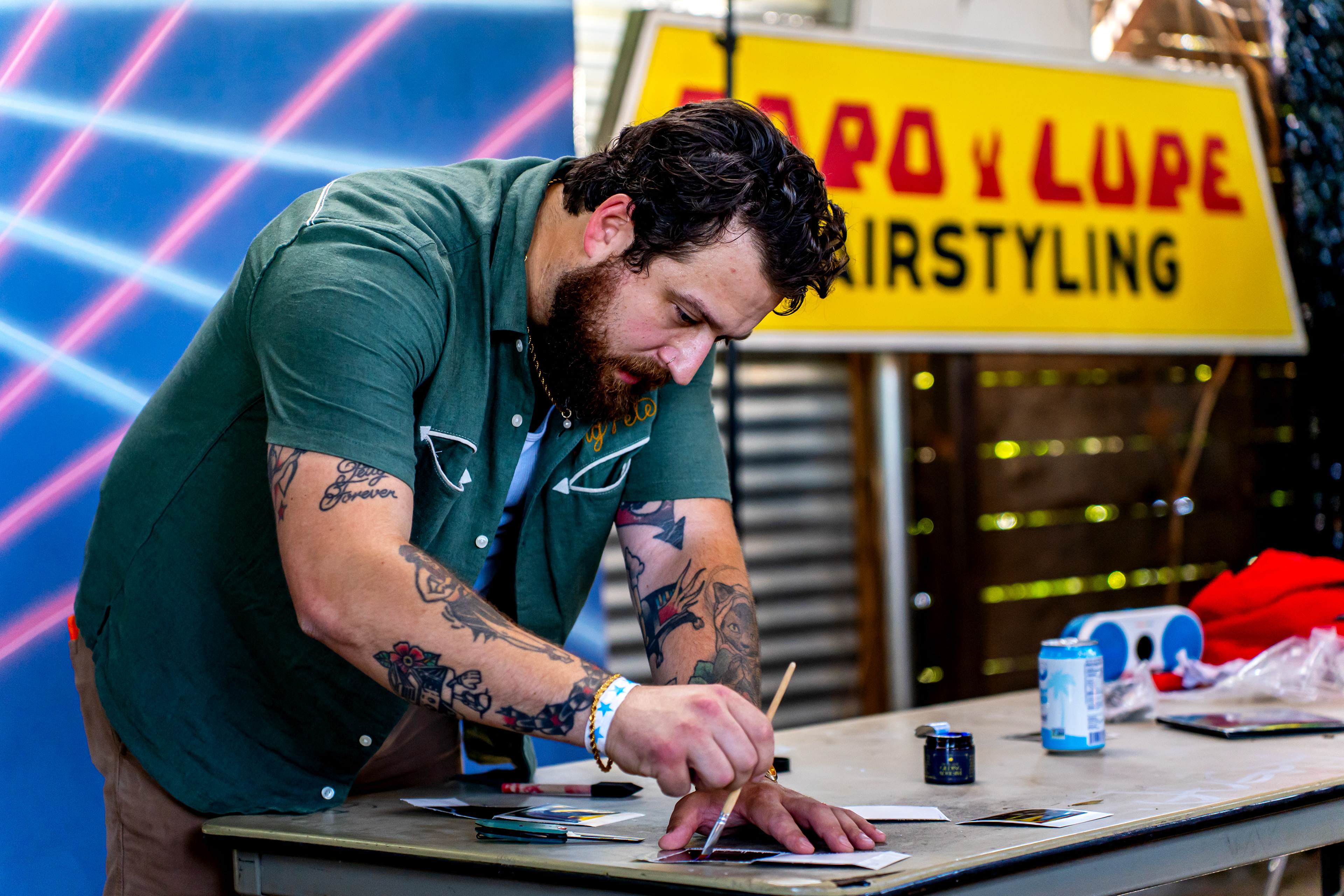 Pete Madden applies adhesive to a transparent Polaroid during his transparencies workshop at Rubber Gloves during Polacon in Denton, TX on Sept. 27, 2025. A transparent Polaroid is created by separating the emulsion side of a Polaroid and revealing a see-through image.