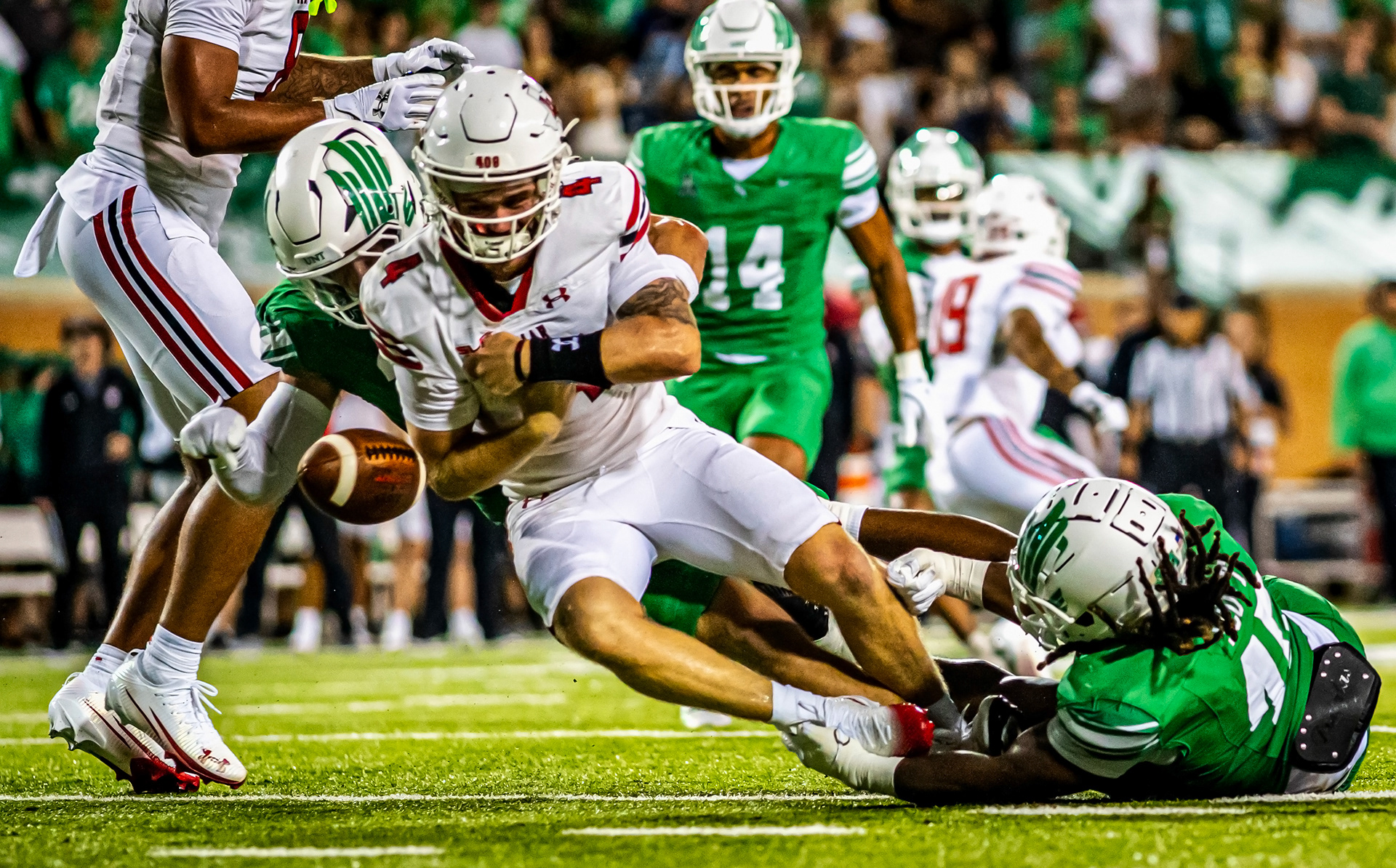 Junior linebacker Ethan Wesloski and redshirt-freshman defensive lineman Zhaiylen Scott force a strip sack at DATCU Stadium on August 30, 2025.