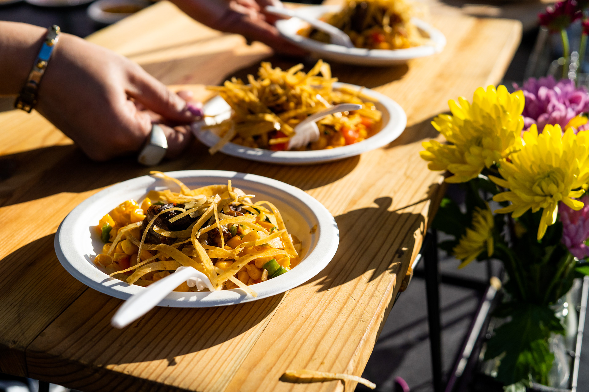 Rosewood wagyu beef short rib, over corn Pico de Gallo served with tortilla chips is plated for guests to eat.