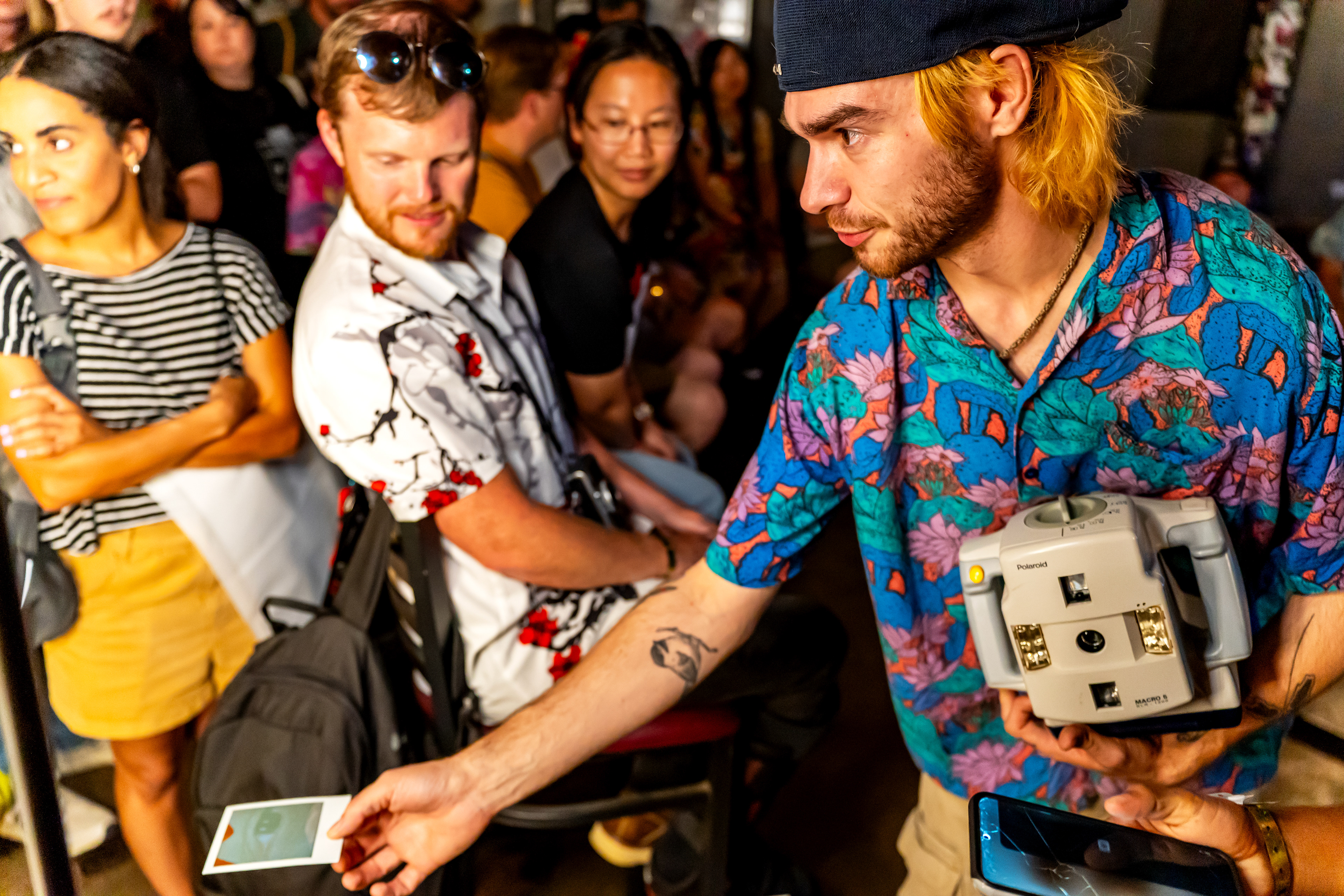 Nick Mass shows attendees the results of the Polaroid he took during Mass' Macro 5 SLR workshop at Rubber Gloves during Polacon in Denton, TX on Sept. 27, 2025.