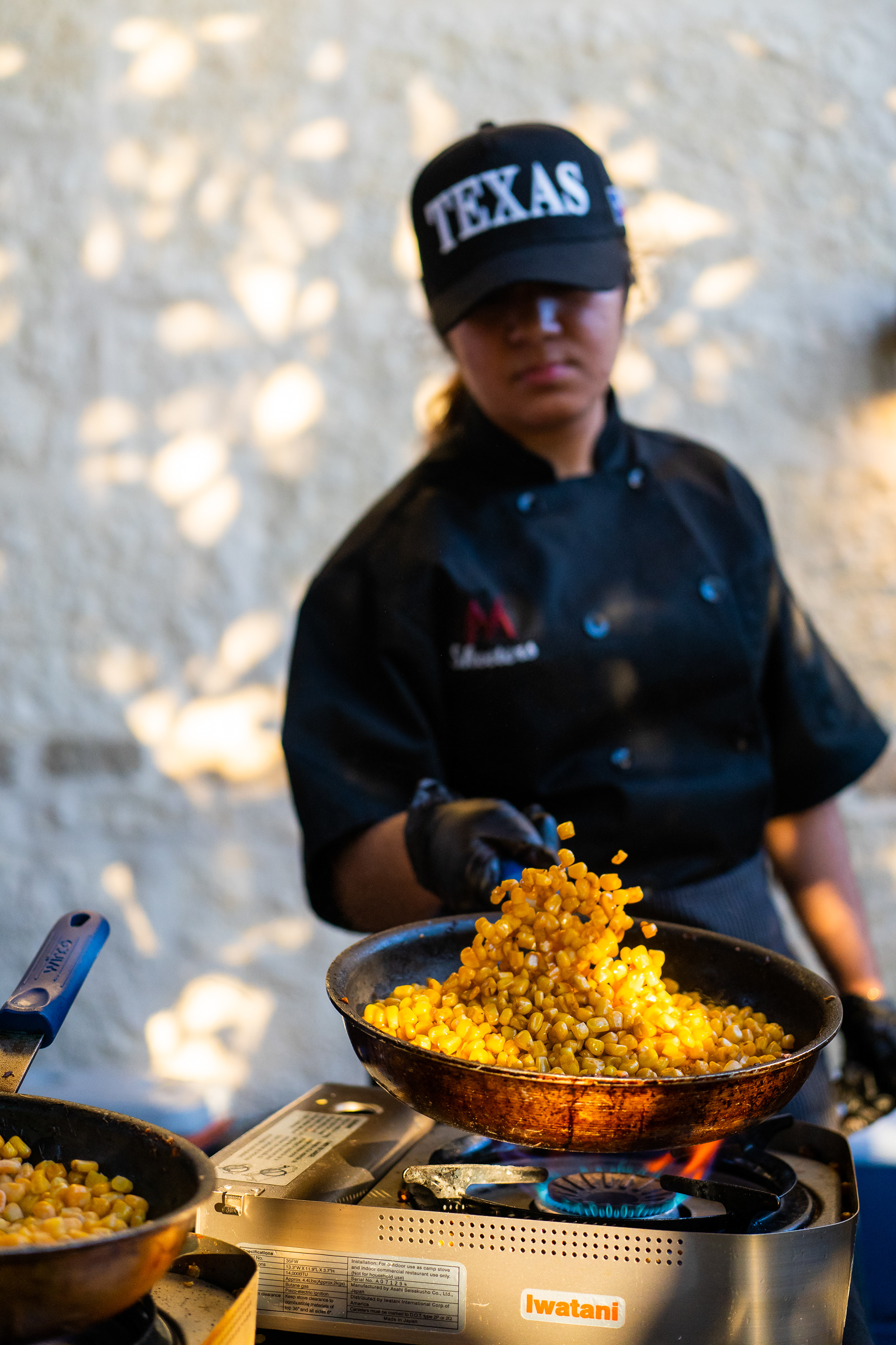 Mesquite High School student Alexa Estevez performs a skillet toss while she cooks roasted corn with queso fresco, cilantro and garnished with tostadas.