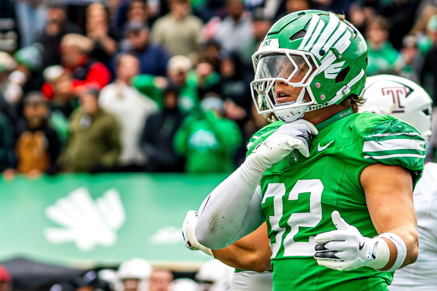 Junior linebacker Ethan Wesloski adjusts his chinstrap between plays against Temple at DATCU Stadium in Denton, TX on Nov. 28, 2025.