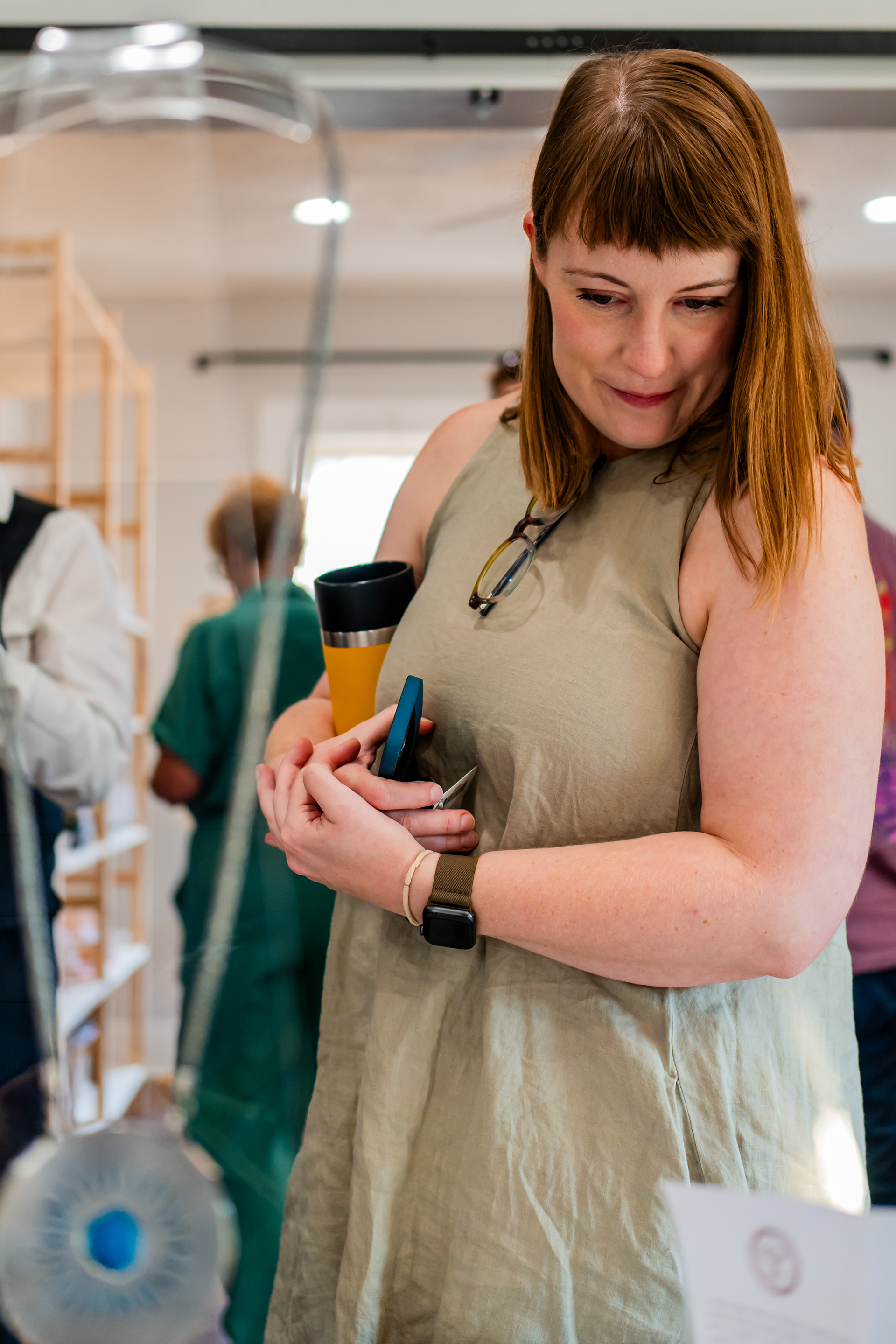 Annette at Auction: Denton Maker Center board member Annette Becker inspects auction item “Magic Mushroom Necklace” by Umut Demirgüç Thurman at the soft open and silent auction event at the Denton Maker Center on Oct. 5, 2024