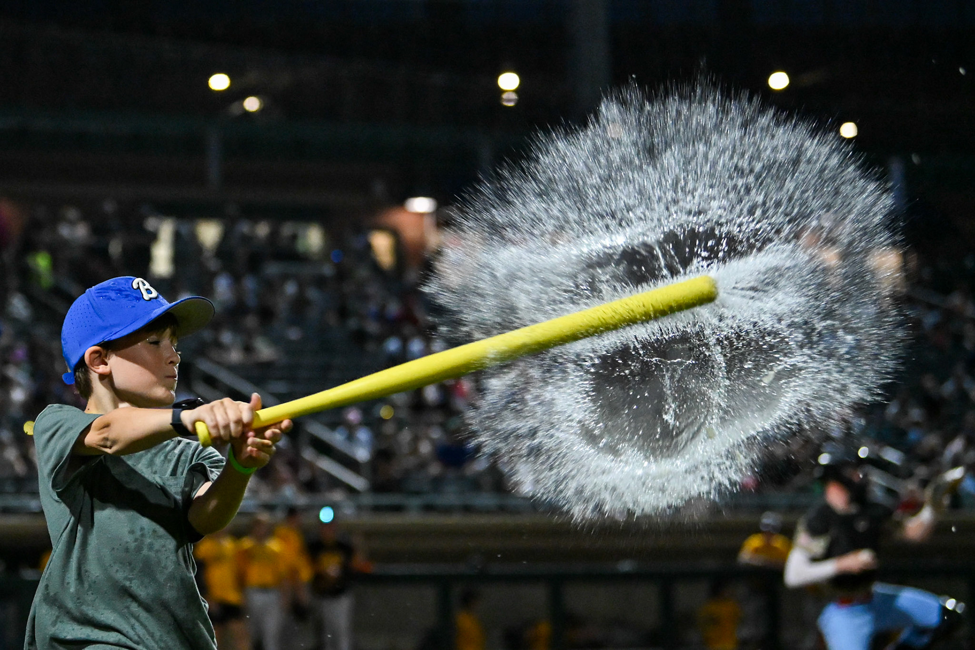 A young Lowell Spinners fan participates in a intermission contest in which two contestants try to bat as many water balloons as possible. The game was played at Edward A. LeLacheur Park in Lowell, MA, on August 8th, 2026.
