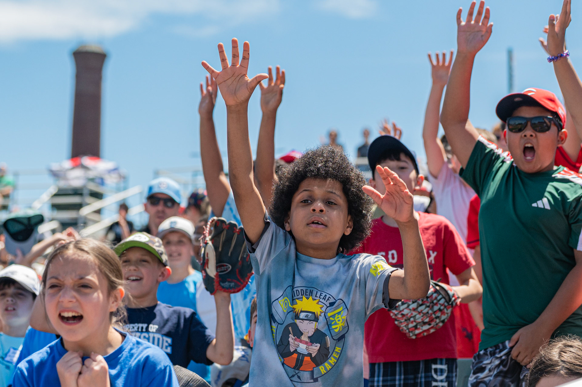 Multiple young Lowell Spinners fans scream as they ask for a t-shirt from the gameday staff. The game was played at Edward A. LeLacheur Park in Lowell, MA, on June 8th 2026