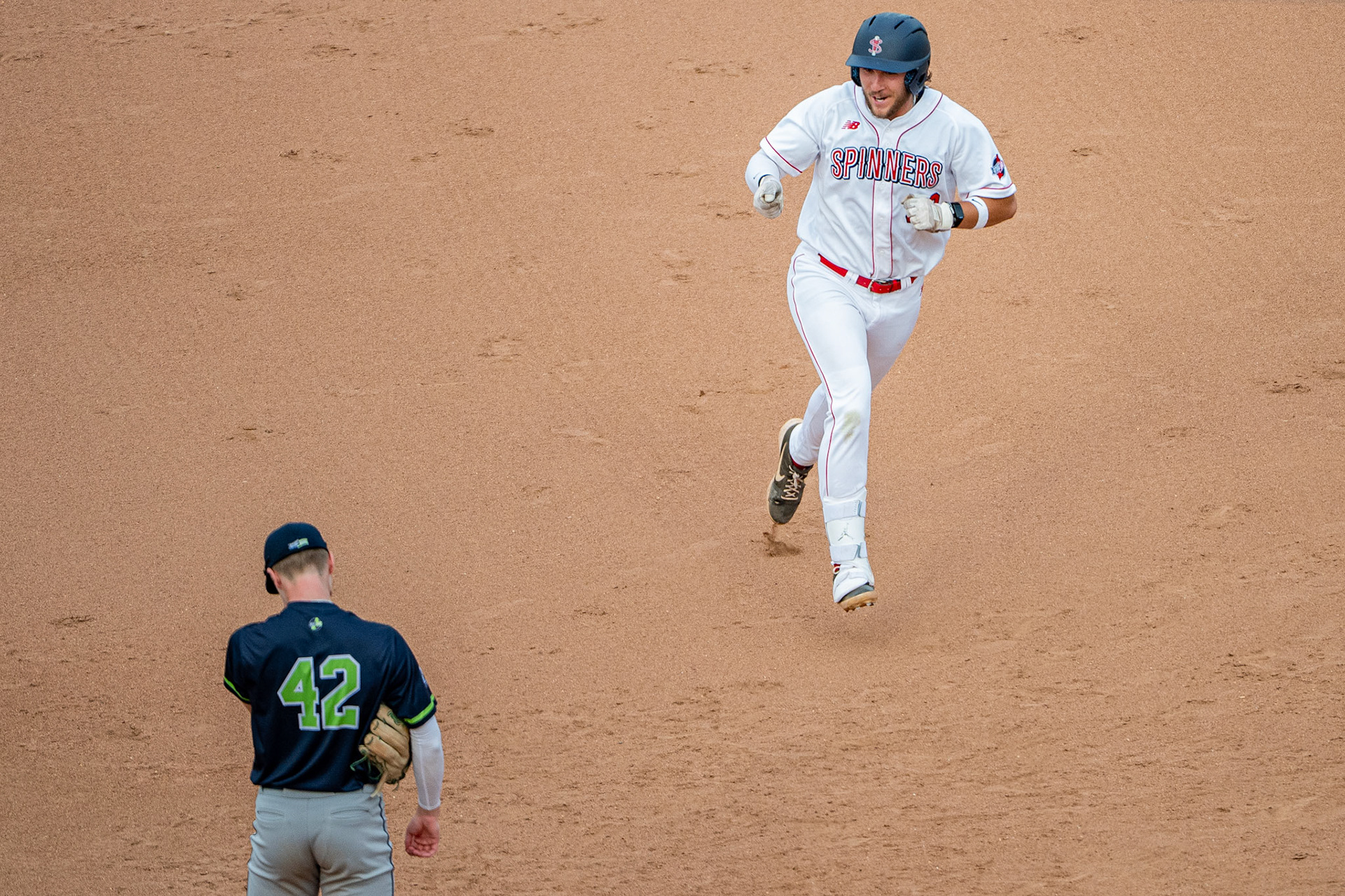 Lowell Spinners' Esteben Dessureault points and laughs at his Worcester Braveheart opponent as he celebrates a home run. The game was played at Edward A. LeLacheur Park in Lowell, MA, on June 6th, 2026.