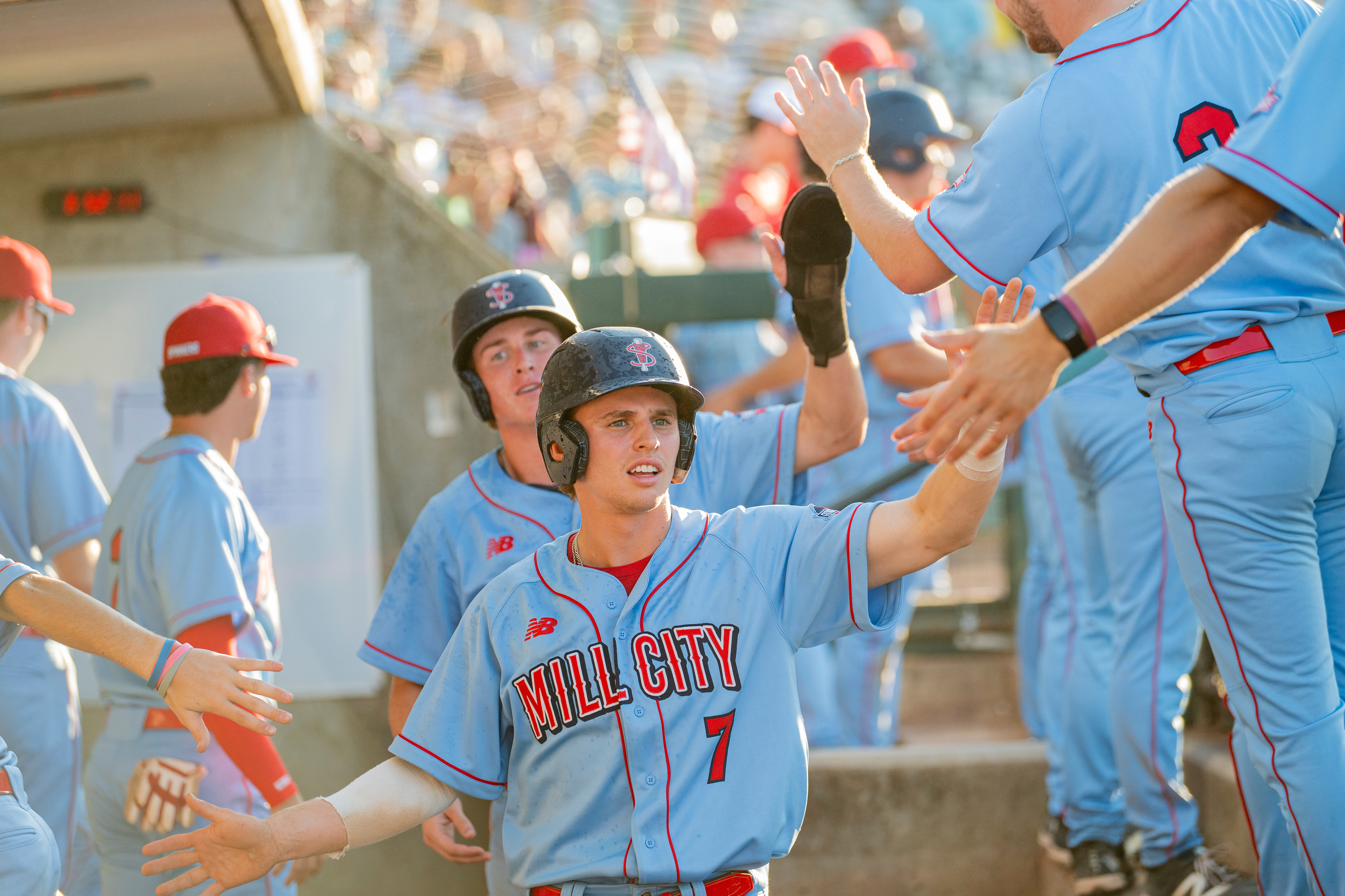 Lowell Spinners' Jack Quigley and Spencer Warfield celebrate in the dugout after scoring two runs during a game at Edward A. LeLacheur Park in Lowell, Massachusetts, on June 28, 2026.