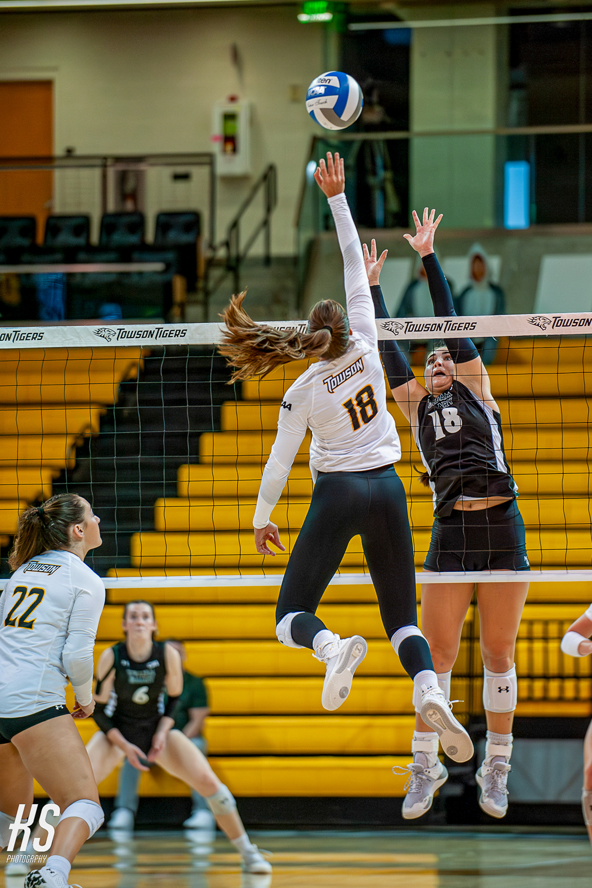 Towson University Volleyball outside hitter Ava Nakai tips the ball over conference rival College of William & Mary’s outside hitter Devereaux Hoxsie during the game at TU Arena in Towson, MD, on September 21, 2024.